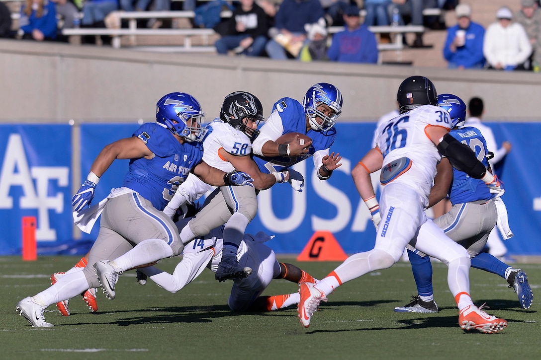 Arion Worthman, quarterback for the U.S. Air Force Academy, gets tackled as the Air Force Falcons met the Boise State Broncos at the Academy's Falcon Stadium in Colorado Springs, Colo., Nov. 25, 2016. Air Force beat No. 19 Boise State 27-20, ending the Broncos' bid for the Mountain West title. The Falcons are heading to their ninth bowl game since coach Troy Calhoun took over in 2007. (U.S. Air Force photo/Mike Kaplan) 
