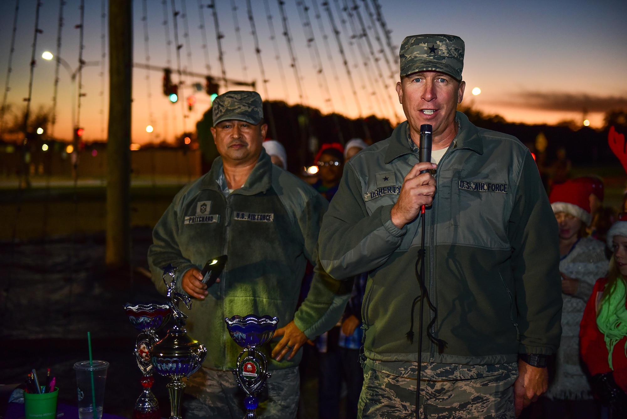 Brig. Gen. Patrick Doherty, 82nd Training Wing commander, and Chief Master Sgt. Joseph Pritchard, 82nd TRW command chief, provide opening comments and introduce the Sheppard Elementary School choir before lighting the holiday tree at Sheppard Air Force Base, Texas, Dec. 1, 2016. Each year in December, Sheppard lights a commemorative tree in the spirit of diversity and celebrating the holidays. (U.S. Air Force photo by Senior Airman Kyle E. Gese)