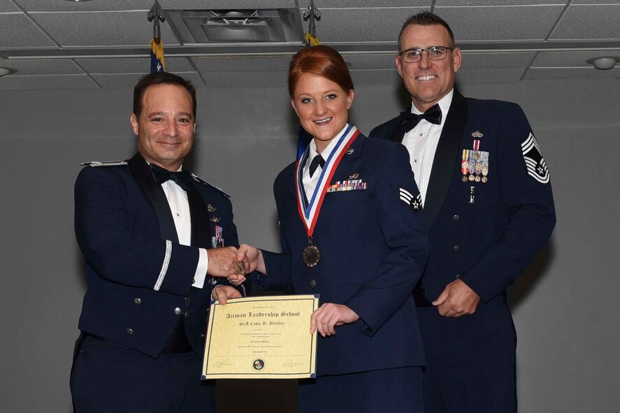 U.S. Air Force Reserve Col. Anthony Brusca, interim commander for the 913th Airlift Group, Senior Airman Casie Bickley, 96 Aerial Port Squadron, and Chief Master Sgt. Ralph Babcock, superintendent, 913th Aircraft Maintenance Squadron, pose for a photo during the Airman Leadership School (ALS) graduation ceremony Dec. 1, 2016, at Little Rock Air Force Base, Ark.  ALS is an Air Force education program held at base level that teaches leadership skills required of supervisors, while strengthening the ability to lead, follow, and manage, which are qualities needed for positions of greater responsibility. (U.S. Air Force photo by Airman 1st Class Kevin Sommer Giron)