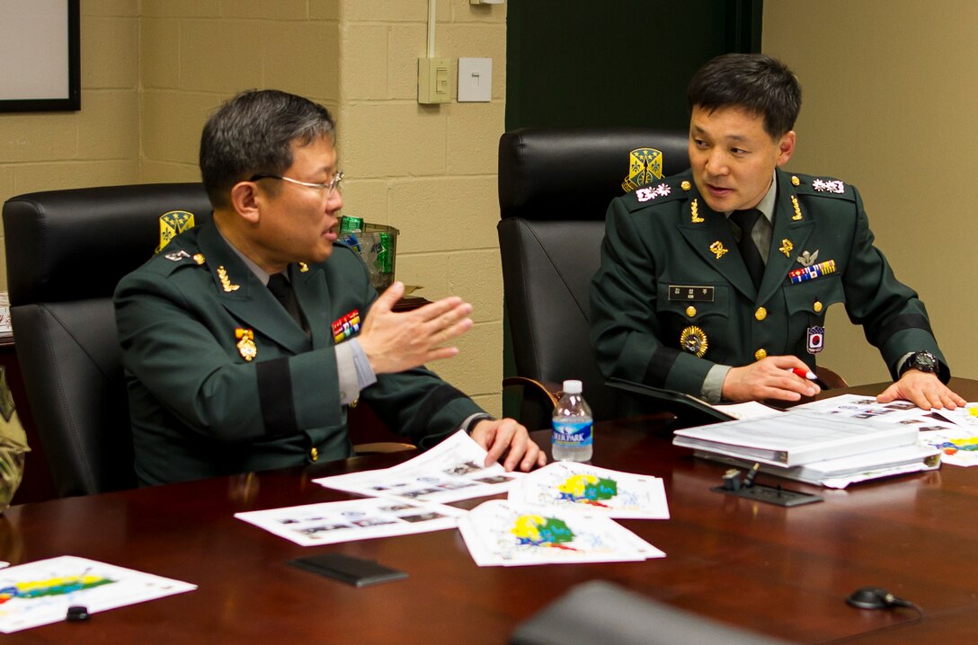 Brig. Gen. Byung Ho Choi, provost marshal for the Republic of Korea Army, and Col. Seung Ju Kim, deputy provost Marshall, discuss operational tactics at the 200th Military Police Command during a briefing at Fort Meade, Maryland, Nov. 30. The briefing informed Choi how how M.P. assets of the U.S. Army Reserve, such as the 200th M.P. Command, operate so that the Republic of Korea can incorporate M.P.'s into their own reserve army. This process benefits the U.S. strategically and tactically by creating interoperability, enhancing security and decreasing dependence on U.S. Forces. (U.S. Army Reserve photo by Sgt. Audrey Hayes)