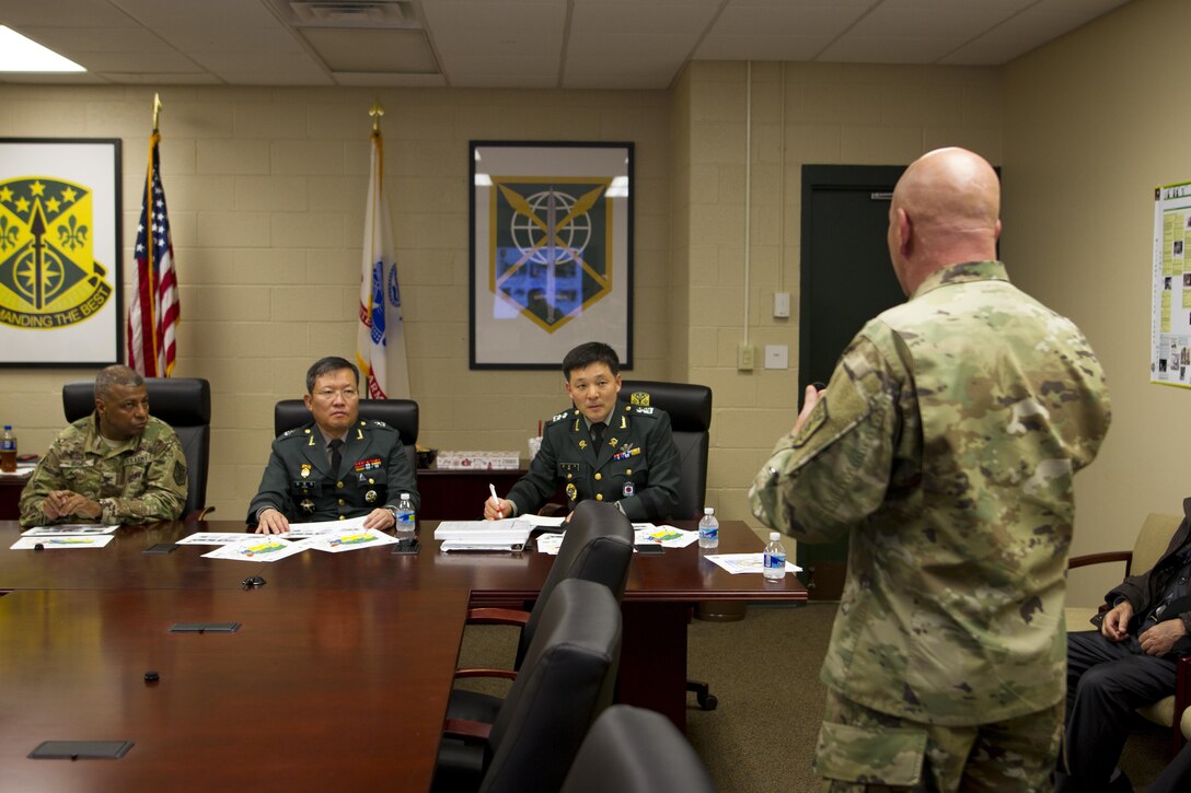 Col. David Dinenna (right), the chief of operations for 200th Military Police Command, briefs Brig. Gen. Byung Ho Choi (center at table), provost marshal for the Republic of Korea Army, at Fort Meade, Maryland, Nov. 30. The briefing assessed how Military Police assets of the U.S. Army Reserve, such as the 200th MP Command, operate so that the Republic of Korea can incorporate M.P.'s in their own reserve army. This process benefits the U.S. strategically and tactically by creating interoperability, enhancing security and decreasing dependence on U.S. Forces. (U.S. Army Reserve photo by Sgt. Audrey Hayes)