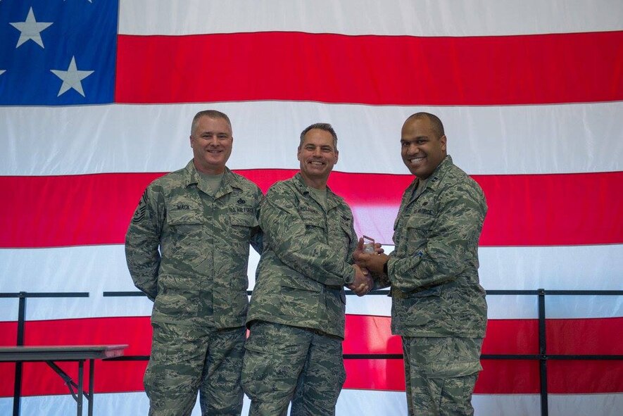 Capt. William-Joseph Mojica, receives the Company Grade Officer of the Quarter award from Col. Tony Polashek, 934th Airlift Wing commander, and Chief Master Sgt. Anthony Mack, 934 AW command chief, at the wing commander's call Nov. 5.