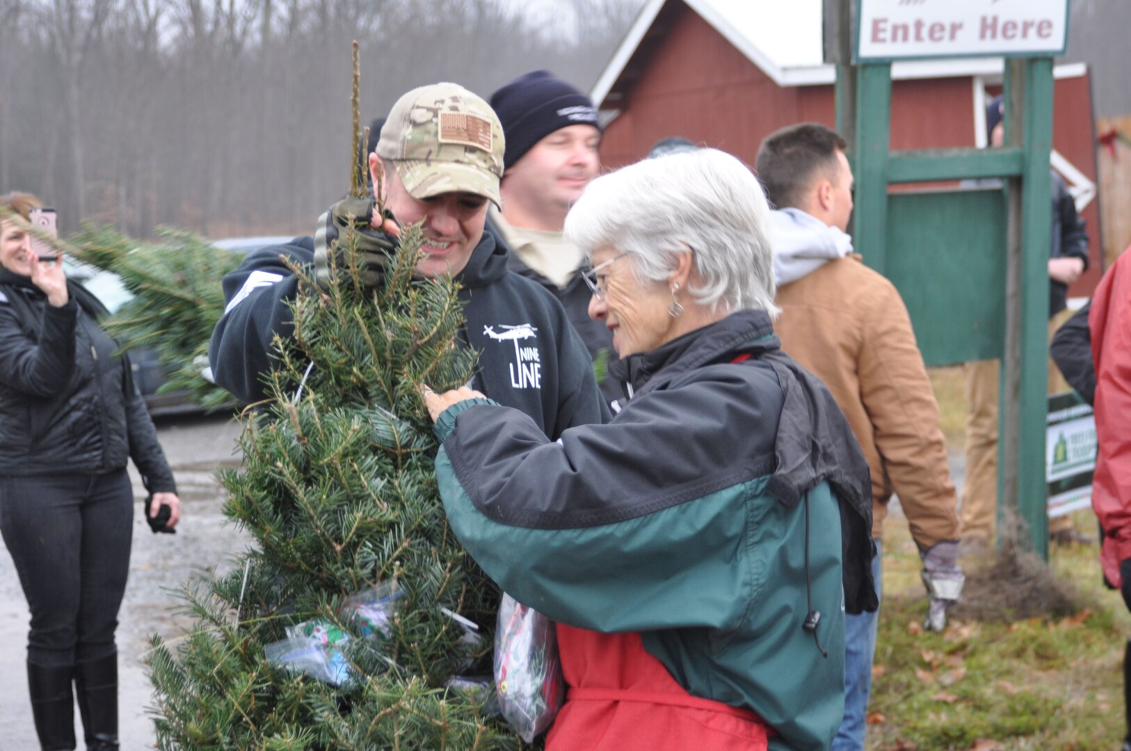 U.S. Air Force Master Sgt. Kyle Defeo helps Sally Ellms pack holiday ornaments and wishes into a Christmas Tree during the loading of donated trees November 29, 2016 in support of Trees for Troops at Ellms Tree Farm in Ballston Spa, N.Y. More than 20 Airmen from the New York Air National Guard’s 109th Airlift Wing based in Scotia, N.Y., helped ship some 130 holiday trees with donated ornaments and holiday wishes.