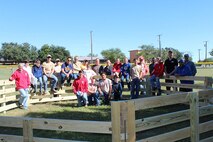 Boy Scouts Troop 280, led by Scoutmaster Katherine Nielander (far left),
poses with a completed gaga ball pit on Laughlin Air Force Base Nov.19. The
gaga ball pit, built for the Laughlin Air Force Base Youth Center as an
Eagle Scout project, allows children here to play a game similar to dodge
ball. (Courtesy photo by Sunshine Burgess)
