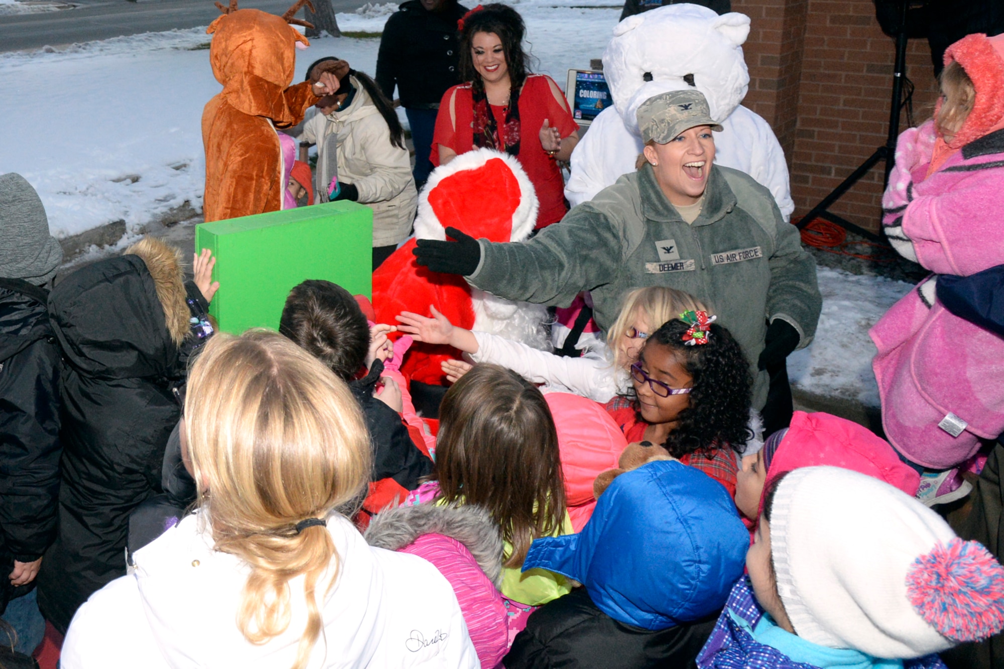 Col. Wendy Deemer, 75th Air Base Wing, joins children to flip a witch, which lights the Hill Air Force Base Christmas tree, Nov. 30. (U.S. Air Force photo by Todd Cromar)