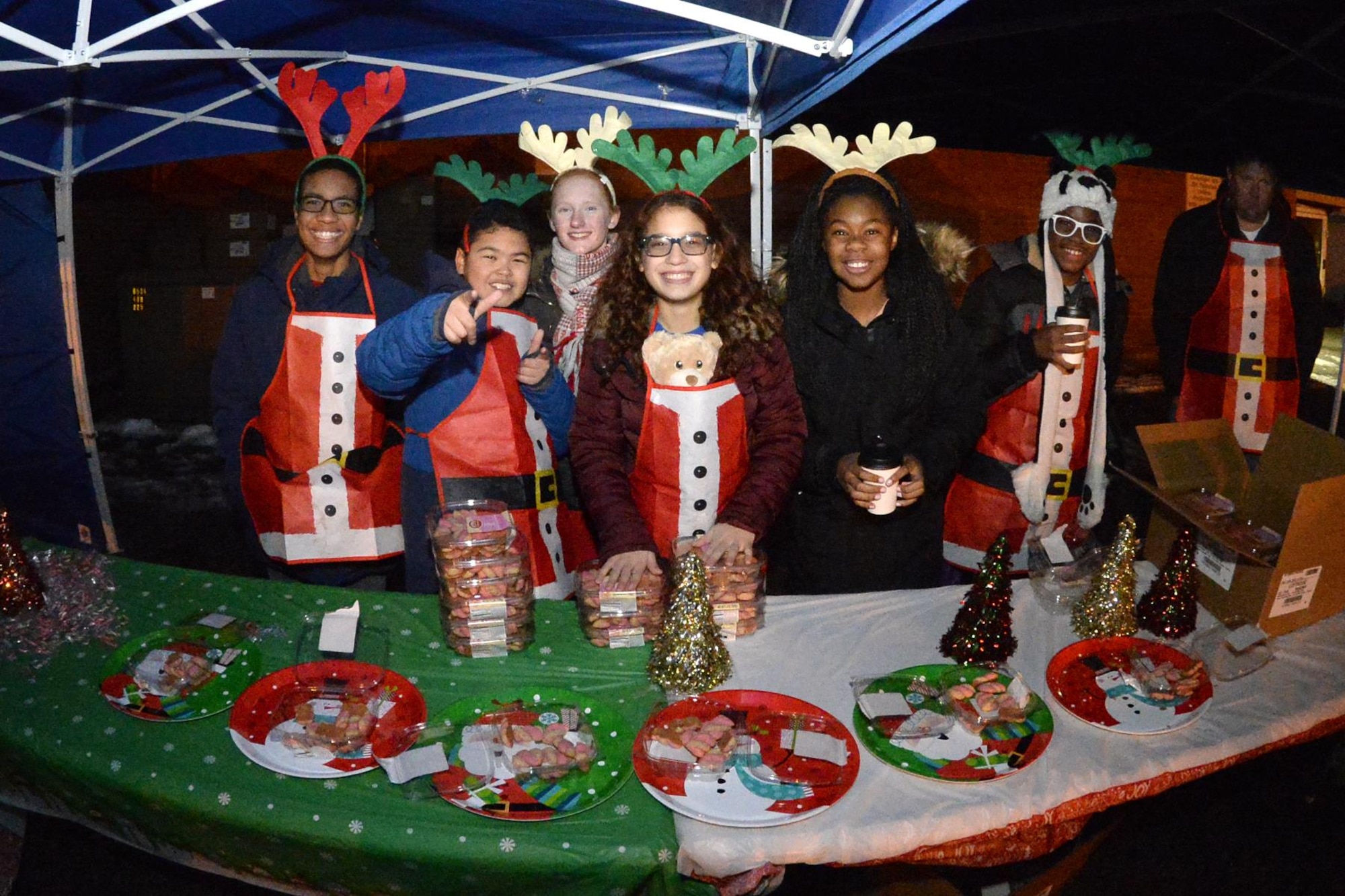 Hill Air Force Base Youth Center volunteers pass out snacks during a holiday celebration Nov. 30 Hill Air Force Base Arts & Crafts Center. (U.S. Air Force photo by Todd Cromar)