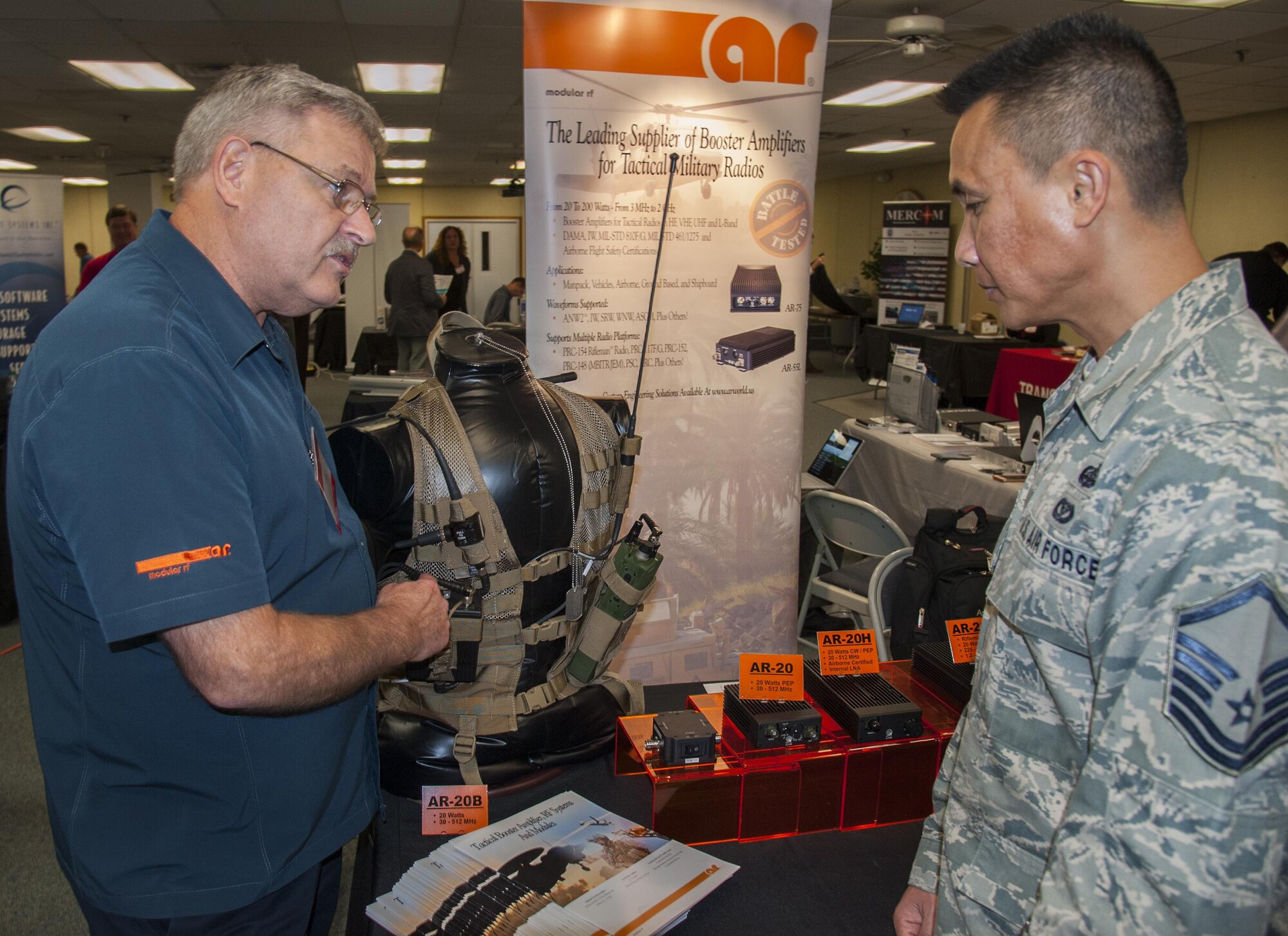 Joe Reminder, from AR RF/Microwave Instrumentation, an amplifier systems company, briefs Master Sgt. Saysomboun Indra, 96th Communications Squadron, on a manpack radio system amplifier, at the Technology Expo, at Eglin Air
Force Base, Fla. Dec. 1.  More than 20 exhibitors from across the country offered information and displays about the latest defense technologies; storage solutions; and logistical and engineering services, among other technologies.  (U.S. Air Force photo/Kevin Gaddie)   

