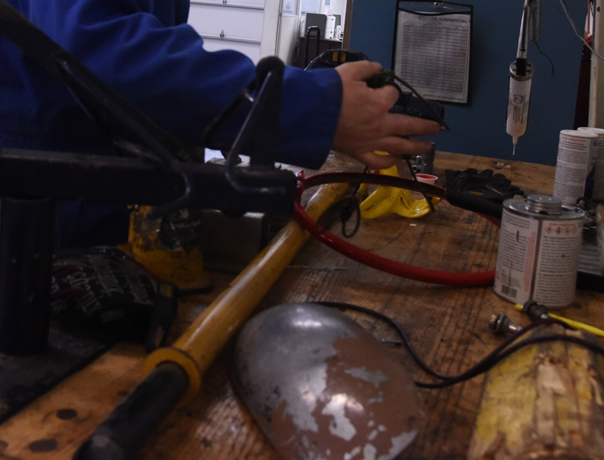 Staff Sgt. Benjamin Fisher, 341st Logistics Readiness Squadron vehicle maintenance journeyman, cleans up a workbench in the LRS tire shop Nov. 30, 2016, at Malmstrom Air Force Base, Mont. The work benches are cleaned when needed to prevent hazards from occurring. (U.S. Air Force photo/Senior Airman Jaeda Tookes)