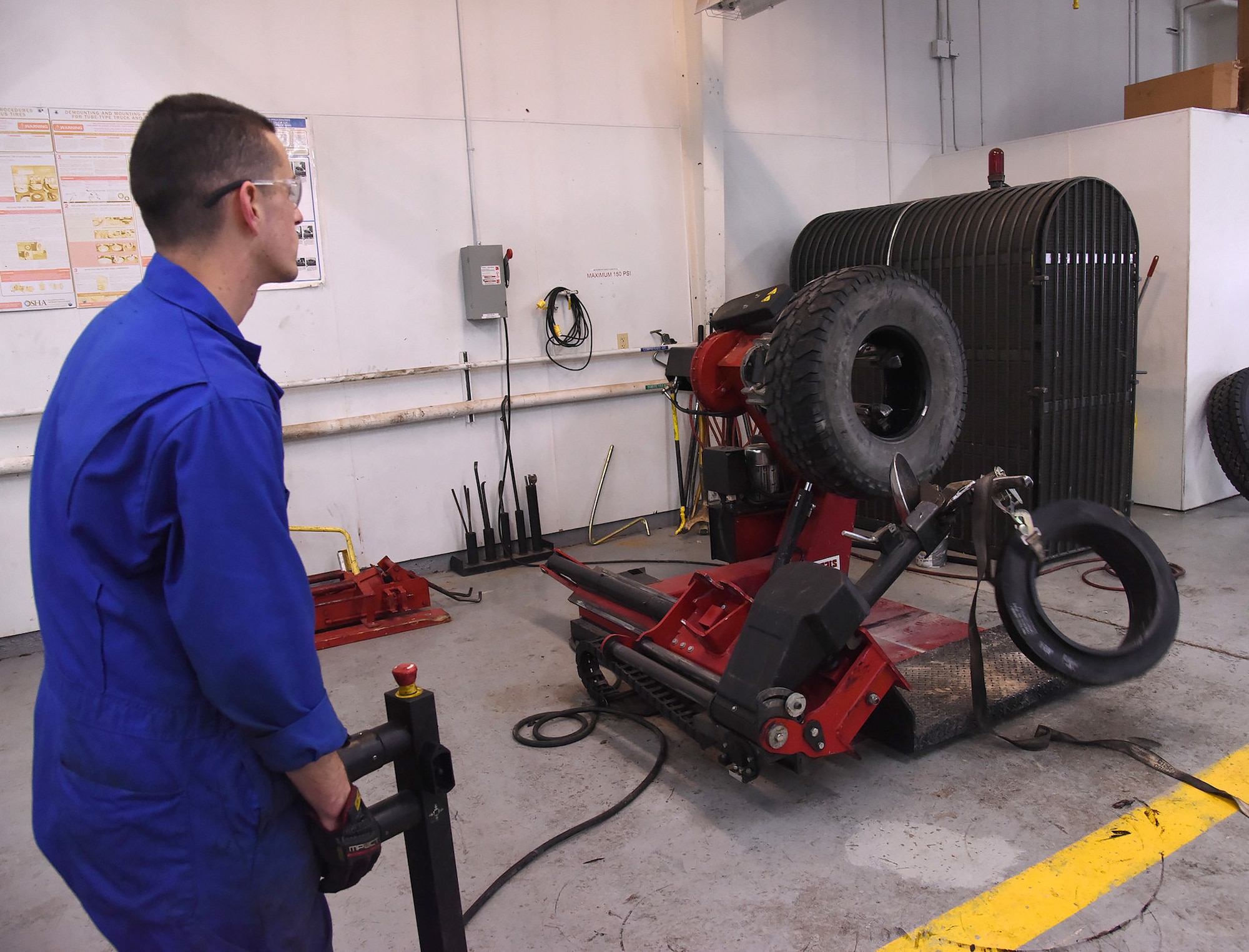 Airman 1st Class Johnathan Allen, 341st Logistics Readiness Squadron vehicle maintenance apprentice, removes run flats from damaged tires to place on new ones Dec. 1, 2016, at Malmstrom Air Force Base, Mont. Run flats are tires designed to resist the effects of deflation if punctured, allowing the driver to continue driving at reduced speeds for a limited distance. (U.S. Air Force photo/Senior Airman Jaeda Tookes)

