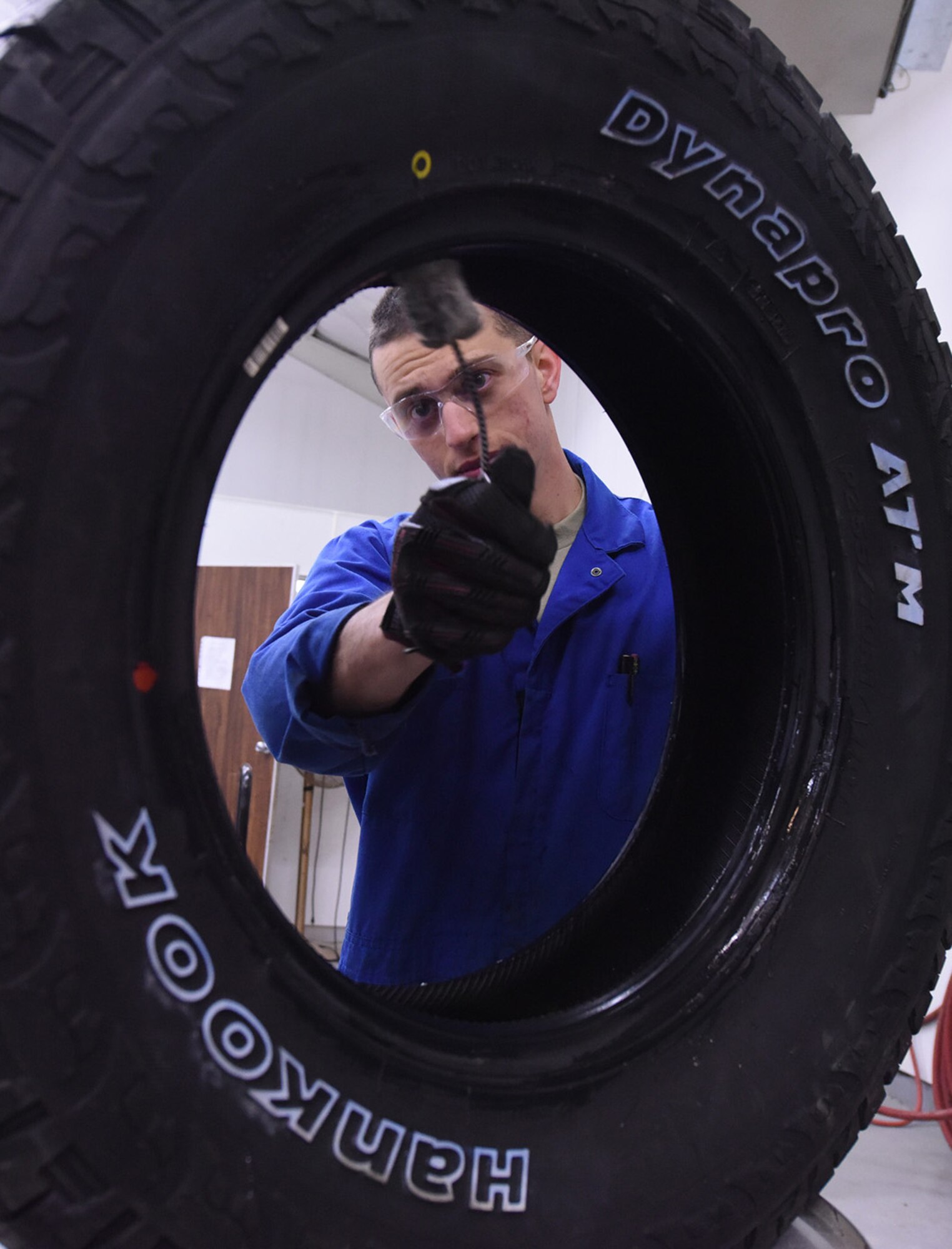 Airman 1st Class Johnathan Allen, 341st Logistics Readiness Squadron vehicle maintenance apprentice, uses tire lube on a light truck tire to easily install the rim at the LRS tire shop Dec. 1, 2016, at Malmstrom Air Force Base, Mont. The tire lube helps with setting the sealant of the tire to prevent it from moving. (U.S. Air Force photo/Senior Airman Jaeda Tookes)
