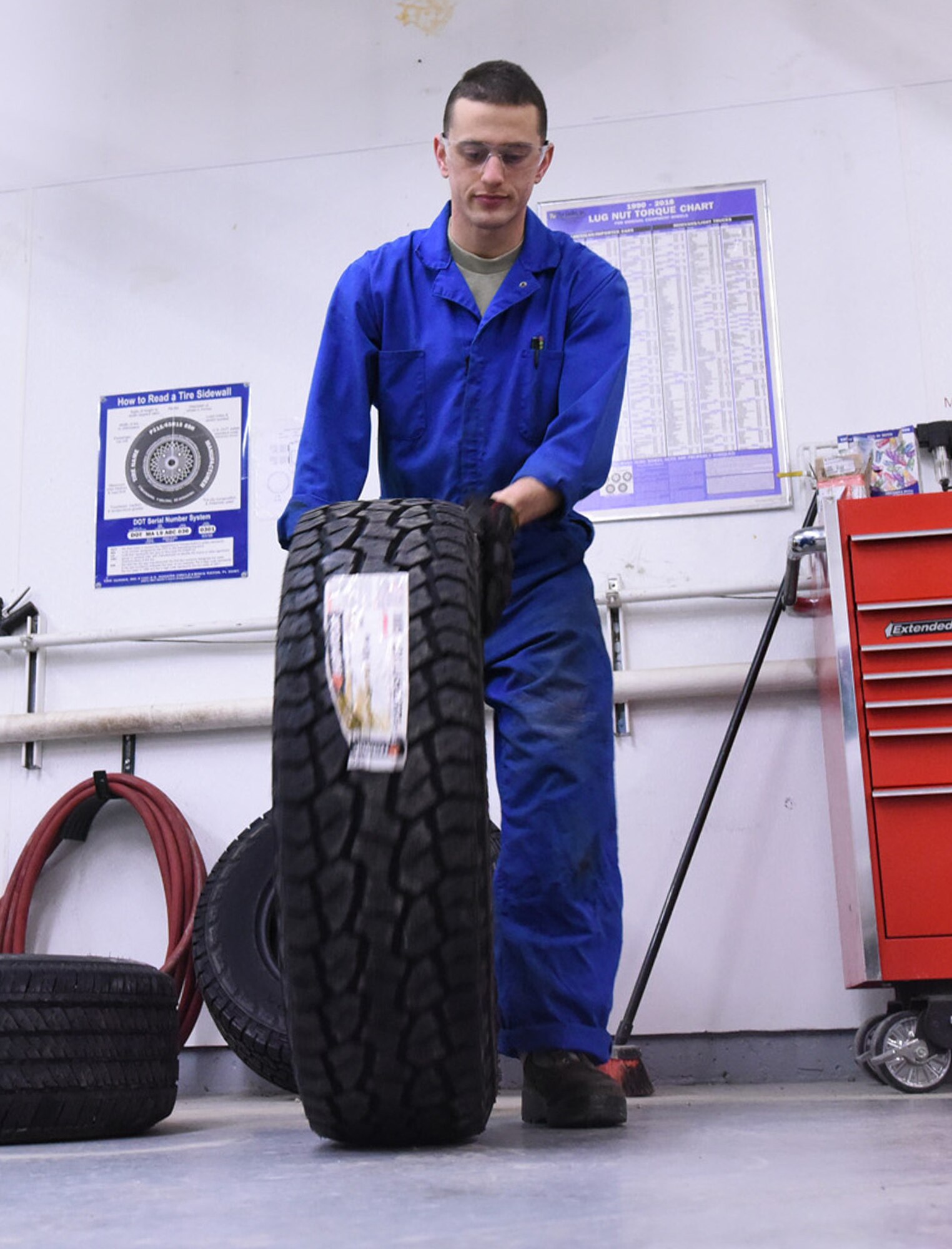 Airman 1st Class Jonathan Allen, 341st Logistics Readiness Squadron vehicle maintenance apprentice, rolls a tire to a tire machine at the LRS tire shop Dec. 1, 2016, at Malmstrom Air Force Base, Mont. The tire machine is used to make it easier to conduct work on the tire. (U.S. Air Force photo/Senior Airman Jaeda Tookes)