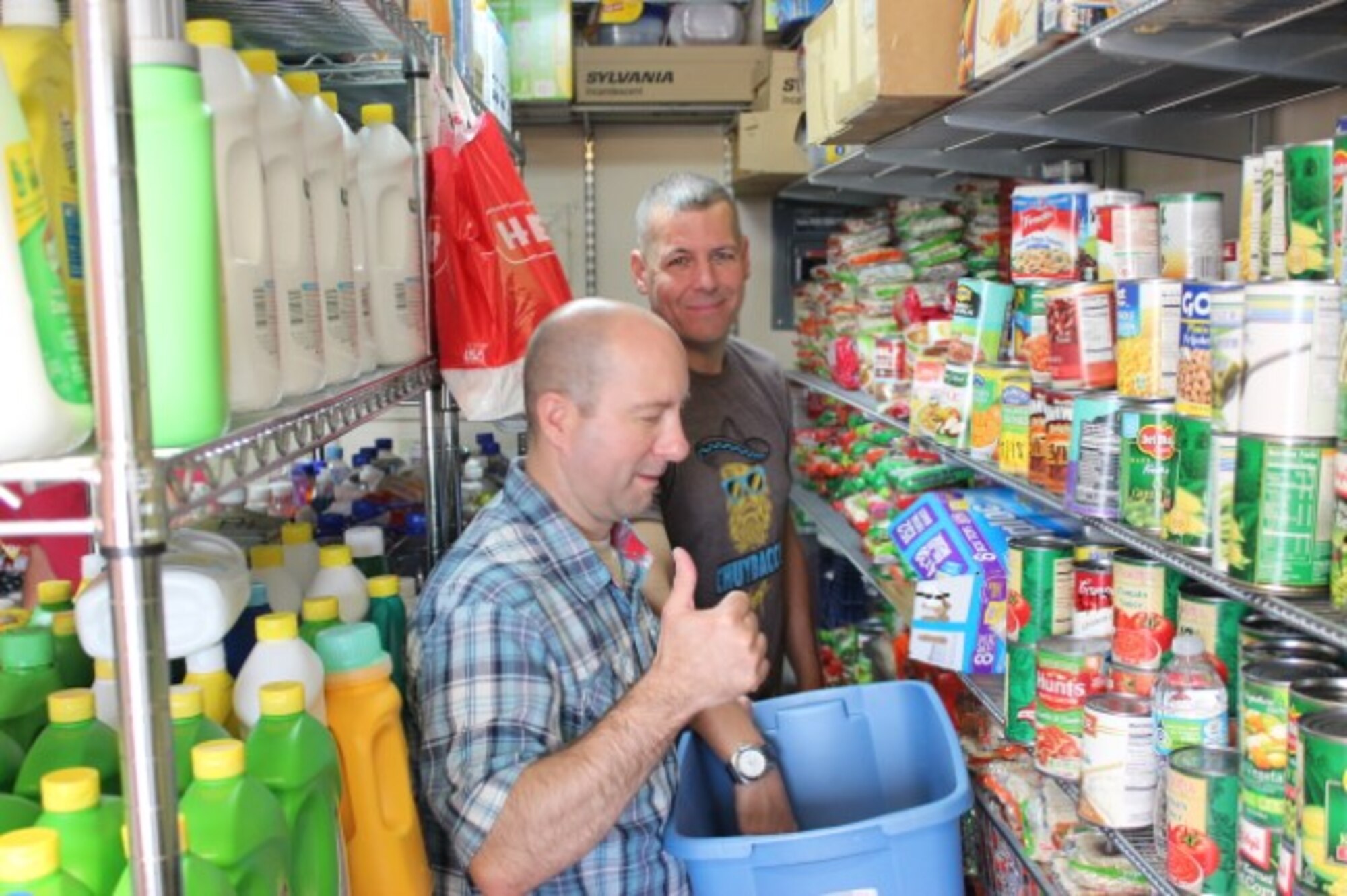 AFOSI Command Chief Master Sgt. Christopher VanBurger, background, and Chief Master Sgt. Charles Garzoni volunteering in the Fisher House Food Pantry during the 2016 AFOSI SNCO Professional Development Seminar at Joint Base San Antonio-Lackland, Texas. (Courtesy photo)  