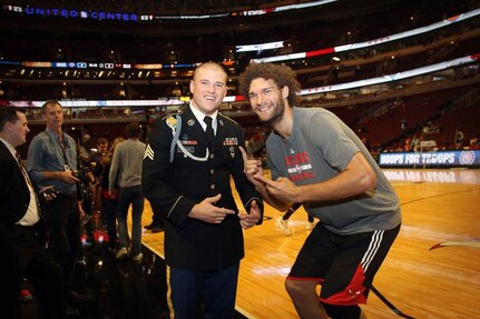 The 2015 U.S. Army Soldier of the Year Sgt. Jared Tansley, Illinois native, meets Chicago Bulls Center, Robin Lopez, before the Chicago Bulls vs. New York Knicks game at the United Center, Nov. 4, 2016. Tansley attended the game as part of a hometown recognition here in Illinois. During his visit, Tansley spoke at numerous locations throughout Chicago and Illinois to include his former high school in Sycamore, Illinois. 
(U.S. Army photo by Anthony L. Taylor)