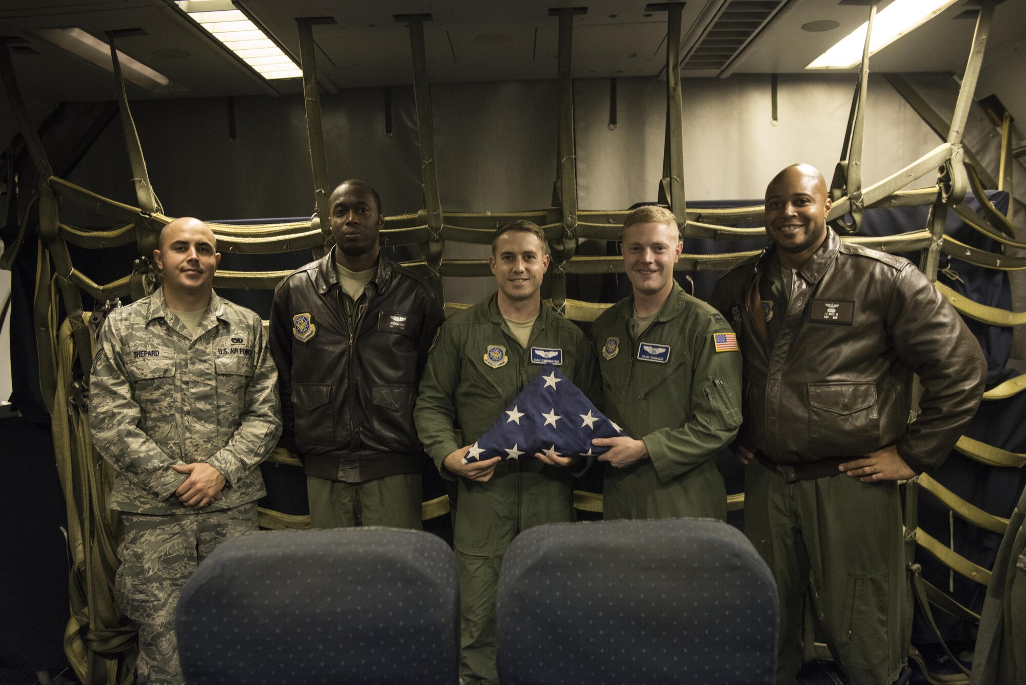 A KC-10 Extender crew from the 32nd Air Refueling Squadron at Joint Base McGuire-Dix-Lakehurst, N.J. poses with Old Glory Nov. 30. Old Glory is an American Flag that has been circling the globe, flying in all places since 1999.