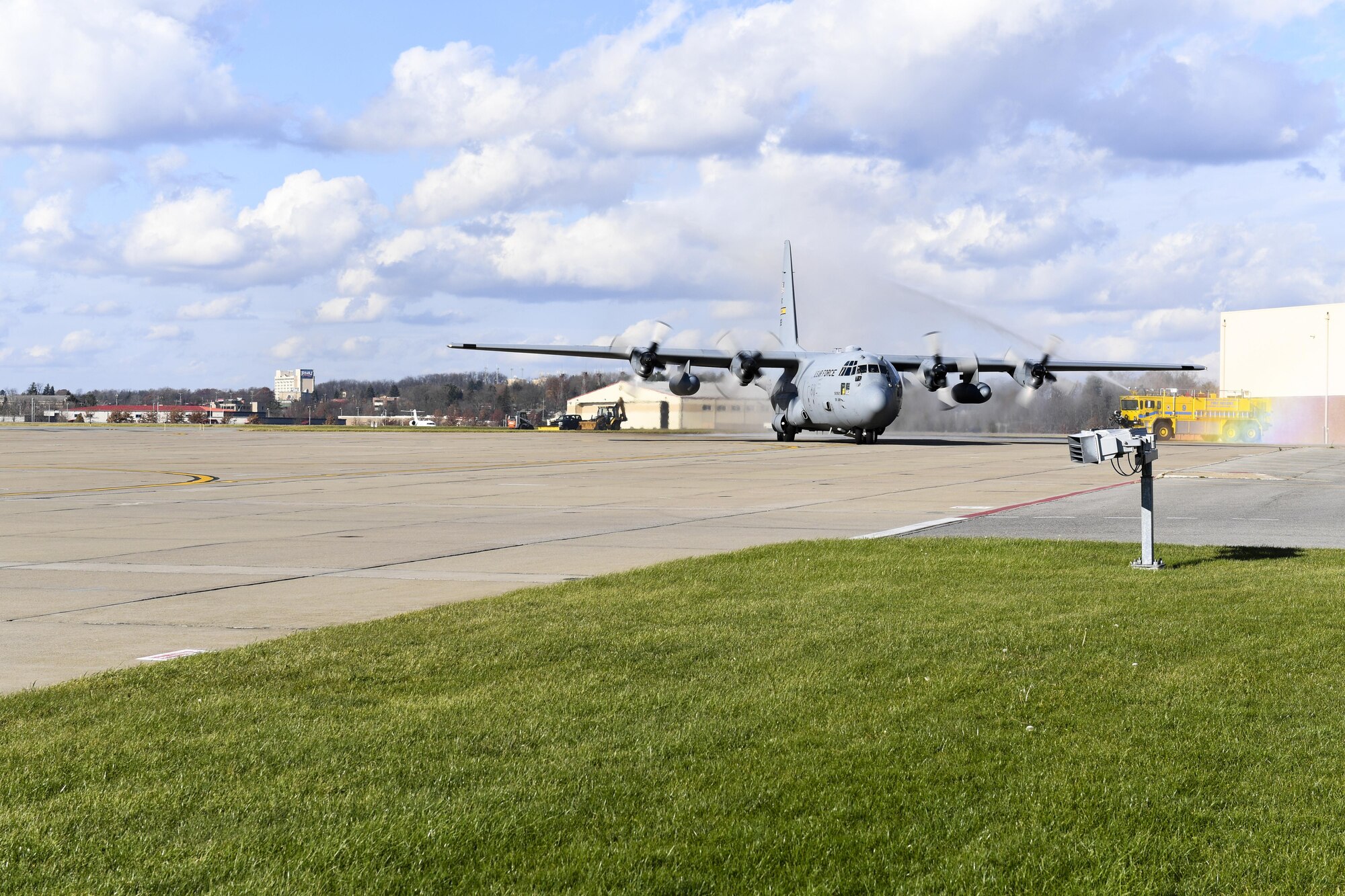 A C-130 Hercules assigned to the 911th Airlift Wing is sprayed by water as is passes by fire trucks at the Pittsburgh International Airport Air Reserve Station, Pennsylvania, Nov. 29, 2016. The aircraft was returning from 911th Operations Group navigator Col. Stan George’s Fini Flight, an Air Force tradition to honor the last flight of a member’s career. (U.S. Air Force photo by Airman 1st Class Beth Kobily)