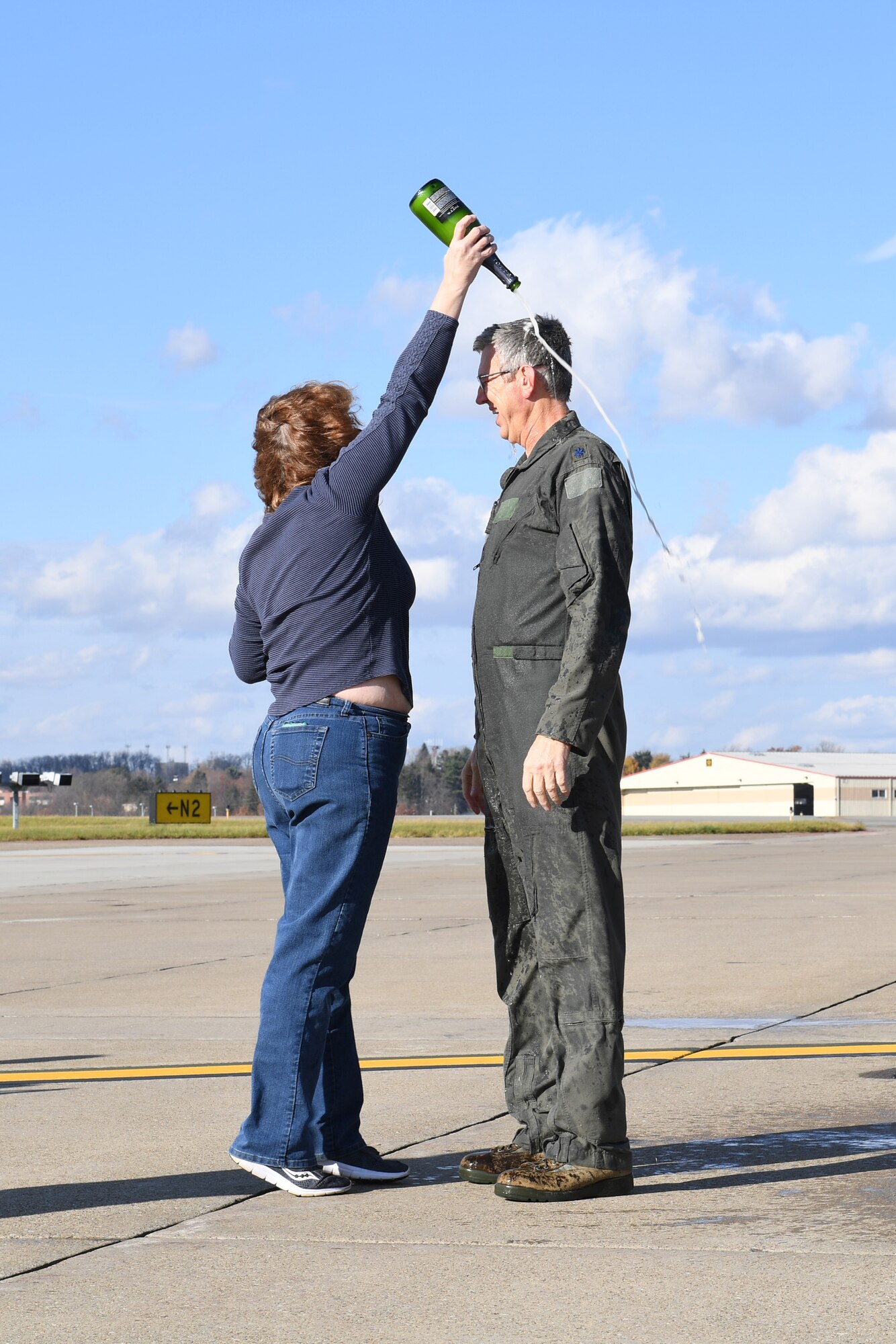 Lt. Col. Stan George, navigator with the 911th Operations Group, is greeted by his wife Annette after his Fini Flight at the Pittsburgh International Airport Air Reserve Station, Pennsylvania, Nov. 29, 2016. This flight marked the end of his 36-year career in the Air Force. (U.S. Air Force photo by Airman 1st Class Beth Kobily)