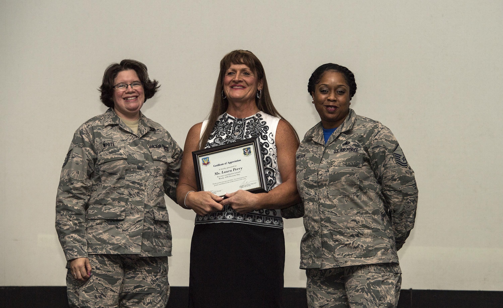 Retired U.S. Air Force Maj. Laura Perry, center, 45th Medical Operations Squadron master social worker, poses for a photo after a speaking engagement, Dec. 2, 2016, at Moody Air Force Base, Ga. Perry spoke about her journey as a transgender veteran and what the opportunity to openly serve has given military members in this community as part of Moody’s Diversity Day celebrating LGBT Pride month. (U.S. Air Force photo by Airman 1st Class Janiqua P. Robinson)