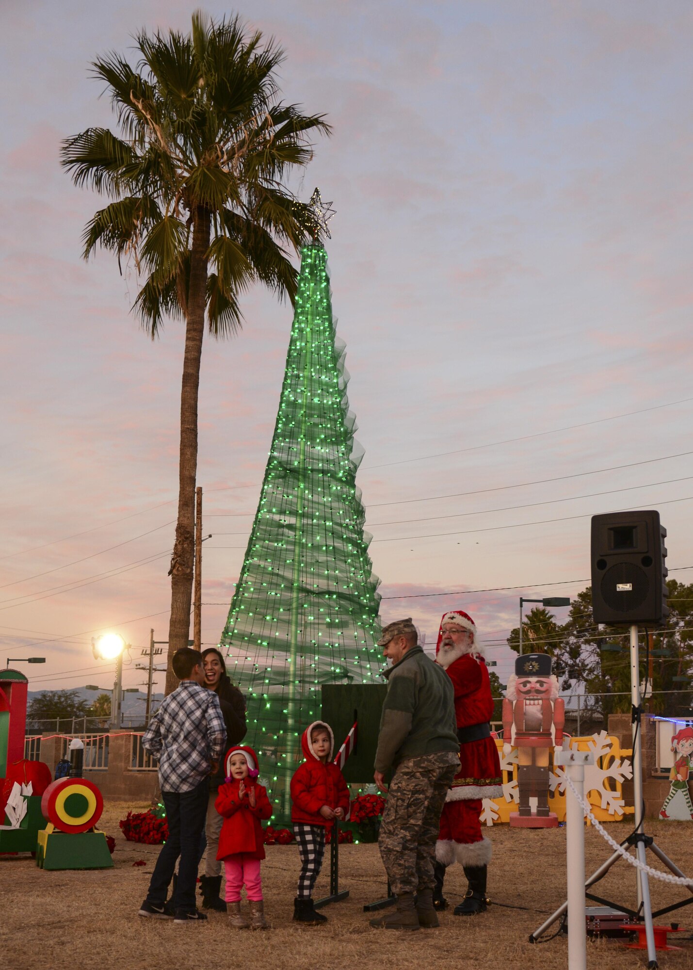 Children of deployed Airmen assist Santa Claus and Col. Scott Campbell, 355th Fighter Wing commander, with lighting the base tree during the Starry, Snowy, Southwest Night holiday celebration at Davis-Monthan Air Force Base, Ariz., Dec. 1, 2016. The event was organized by the 355th Force Support Squadron and Outdoor Recreation with approximately 20 Airmen, spouse, retired and civilian volunteers assisting during it. (U.S. Air Force photo by Airman Nathan H. Barbour)
