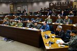 Rear Adm. Brad Cooper, commander of U.S. Naval Forces Korea, and Republic of Korea Navy Rear Adm, Kim, Jong-Il, deputy commander of ROK Fleet, review briefs prior to beginning an Anti-Submarine Warfare Working Group in Busan, Dec. 1, 2016. The working group, co-hosted by CNFK and ROK Fleet, brought together personnel from 17 U.S. and ROK commands to discuss ways both navies can improve ASW capabilities. This is the fifth meeting solely focused on ASW since a cooperation charter was signed in 2014. 
