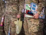 Army explosive ordnance disposal students hold toys while waiting to march over to the base’s toy drive at Eglin Air Force Base, Fla, Dec. 1.  After base retreat, the formation marched over to Bldg. 615 to drop off the toys.  (U.S. Air Force photo/Samuel King Jr.)