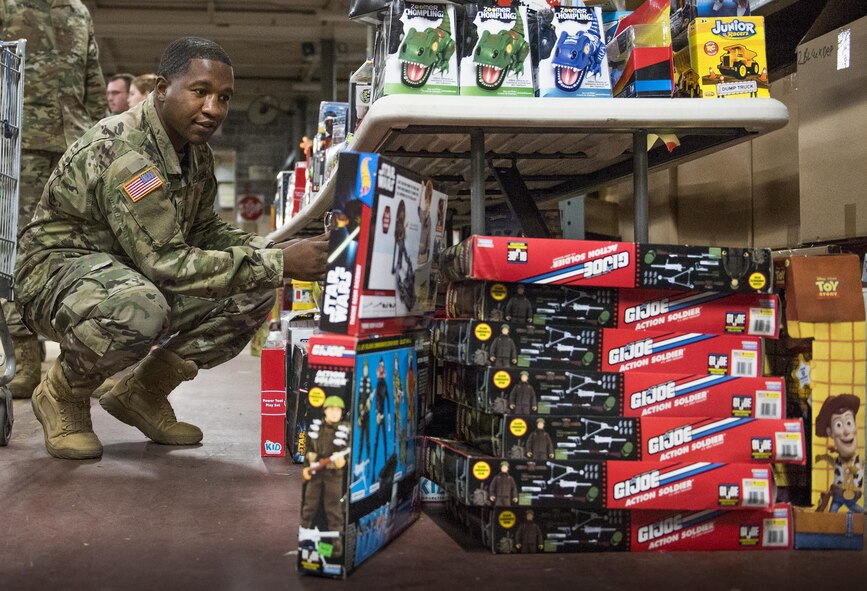 An Army specialist checks out the toys on display during the base’s annual toy drive at Eglin Air Force Base, Fla., Dec. 2. Approximately 2,000 toys were collected by donations made throughout the year. Toys, bikes, books, games, crafts, sports equipment and stuffed animals were given to active-military families in need of assistance during the holidays. (U.S. Air Force photo/Samuel King Jr.)