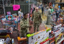 An Army specialist checks out the toys on display during the base’s annual toy drive at Eglin Air Force Base, Fla., Dec. 2. Approximately 2,000 toys were collected by donations made throughout the year. Toys, bikes, books, games, crafts, sports equipment and stuffed animals were given to active-military families in need of assistance during the holidays. (U.S. Air Force photo/Samuel King Jr.)