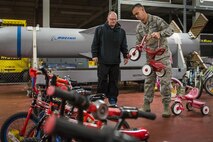 A first sergeant helps a parent choose a tricycle during the base’s annual toy drive at Eglin Air Force Base, Fla., Dec. 2. Approximately 2,000 toys were collected by donations made throughout the year. Toys, bikes, books, games, crafts, sports equipment and stuffed animals were given to active-military families in need of assistance during the holidays. (U.S. Air Force photo/Samuel King Jr.)
