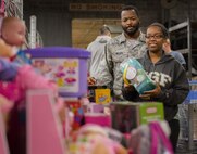 An Airman and his spouse check out the girls’ toy section during the base’s annual toy drive at Eglin Air Force Base, Fla., Dec. 2. Approximately 2,000 toys were collected by donations made throughout the year. Toys, bikes, books, games, crafts, sports equipment and stuffed animals were given to active-military families in need of assistance during the holidays. (U.S. Air Force photo/Samuel King Jr.)