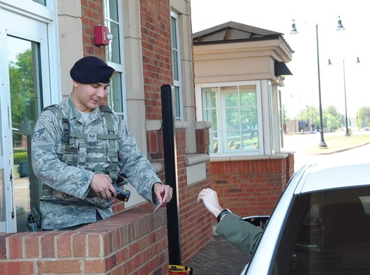 Senior Airman Patrick Shirley, 14th Security Forces Squadron Patrolman, checks the identification of a Team BLAZE member attempting to go through the main gate May 5 at Columbus Air Force Base, Mississippi. Although the main gate is open 24/7 unless otherwise stated, the back gate is only open from 6 a.m. – 6 p.m. Monday – Friday, and is closed on weekends and federal holidays. (U.S. Air Force photo by Senior Airman Kaleb Snay)