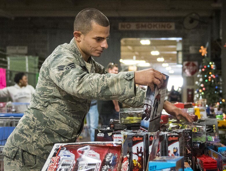 A senior airman checks out an Ant Man action figure during the base’s annual toy drive at Eglin Air Force Base, Fla., Dec. 2. Approximately 2,000 toys were collected by donations made throughout the year. Toys, bikes, books, games, crafts, sports equipment and stuffed animals were given to active-military families in need of assistance during the holidays. (U.S. Air Force photo/Samuel King Jr.)