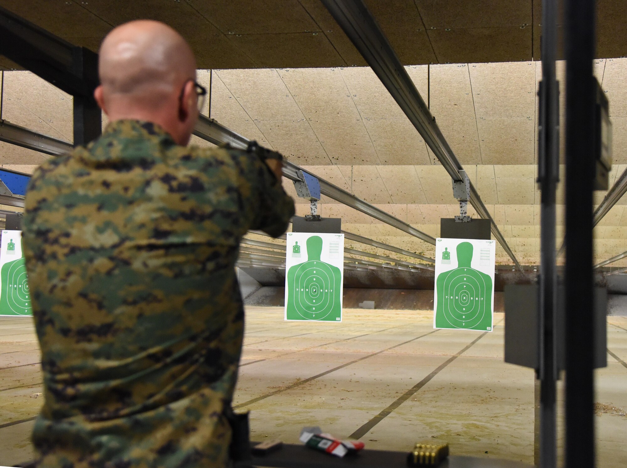 U.S. Marine Corps Gunnery Sgt. Michael Heacock, Keesler Marine Detachment instructor, participates in the 81st Security Forces Squadron “Top Shot” competition Dec. 1, 2016, on Keesler Air Force Base, Miss. The event was held at the indoor firing range to raise funds for the Combined Federal Campaign. (U.S. Air Force photo by Kemberly Groue)