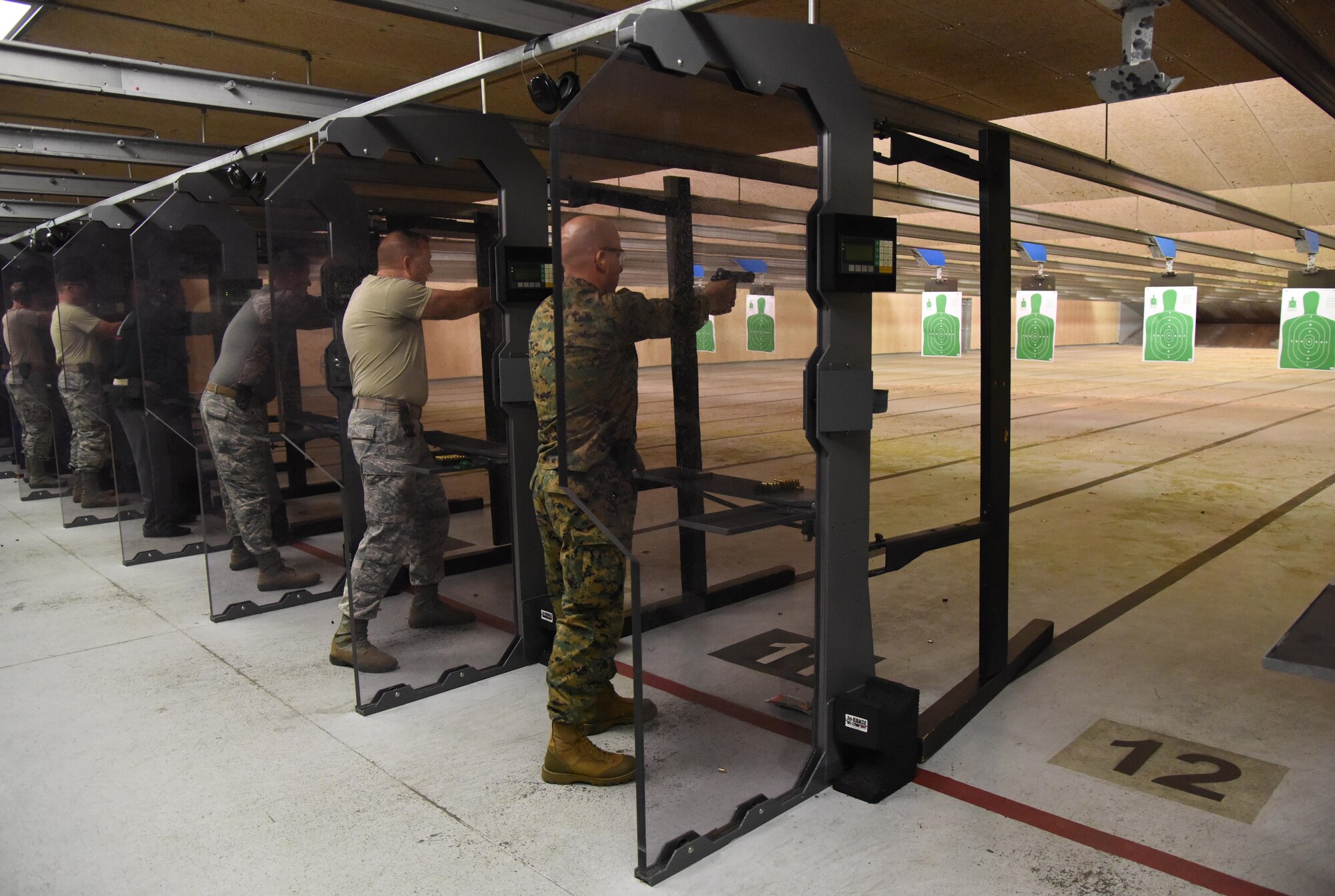 Keesler personnel participate in the 81st Security Forces Squadron “Top Shot” competition Dec. 1, 2016, on Keesler Air Force Base, Miss. The event was held at the indoor firing range to raise funds for the Combined Federal Campaign. (U.S. Air Force photo by Kemberly Groue)