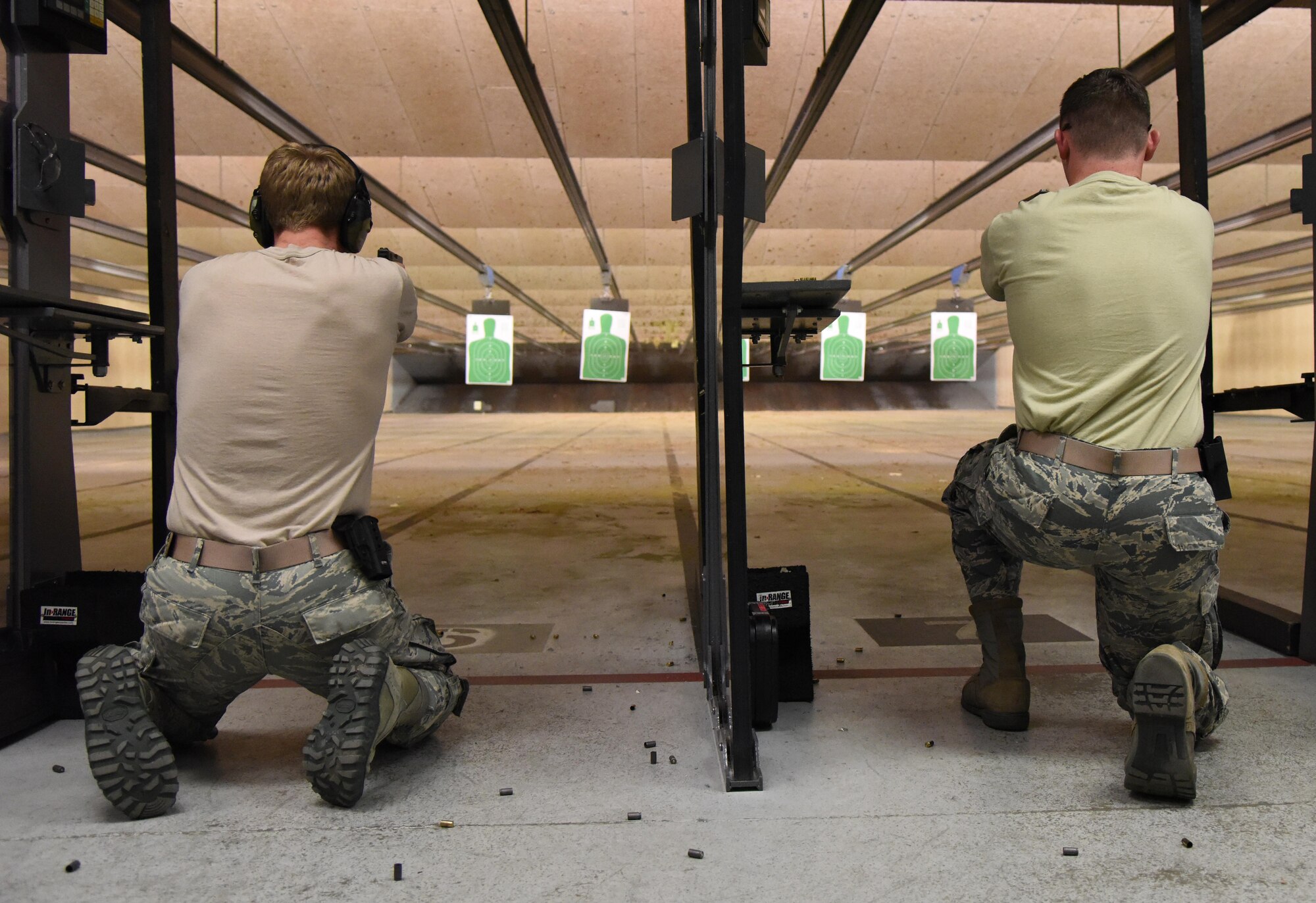 Senior Airmen Alec Rawlings and Sean Campbell, 81st Dental Squadron dental laboratory technicians, participate in the 81st Security Forces Squadron “Top Shot” competition Dec. 1, 2016, on Keesler Air Force Base, Miss. The event was held at the indoor firing range to raise funds for the Combined Federal Campaign. (U.S. Air Force photo by Kemberly Groue)