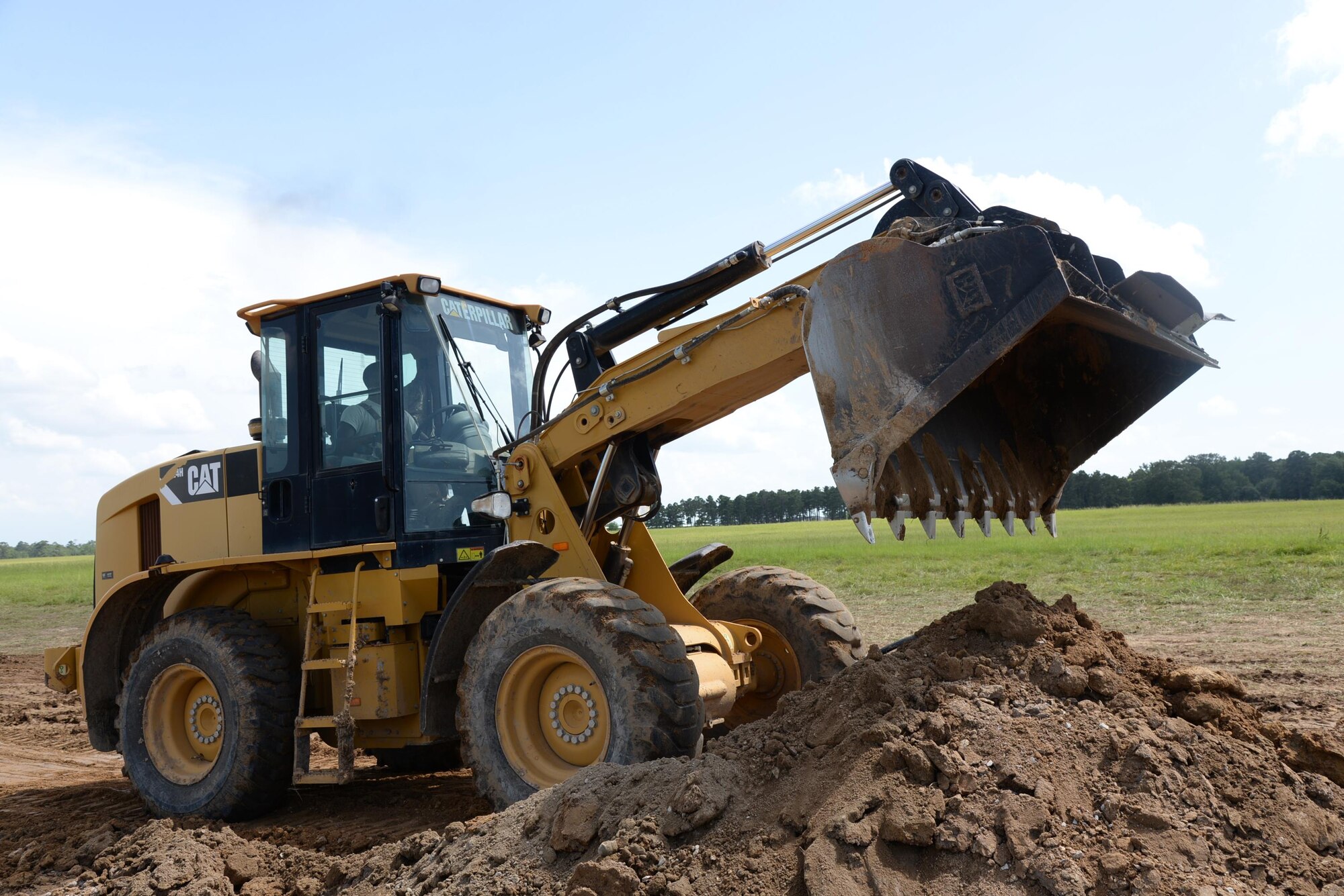 Staff Sgt. Forrest Dickson, 823rd Rapid Engineer Deployable Heavy Operational Repair Squadron, Engineering, Hurlburt Field, Florida, shovels excess dirt on the flightline of Columbus Air Force Base, Mississippi, July 12. REDHORSE is currently on a flightline Radio Select Unit project and is scheduled to begin paving Perimeter Road July 18. (U.S. Air Force photo/Airman 1st Class John Day)