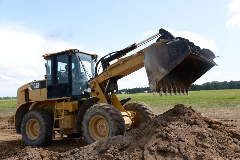 Staff Sgt. Forrest Dickson, 823rd Rapid Engineer Deployable Heavy Operational Repair Squadron, Engineering, Hurlburt Field, Florida, shovels excess dirt on the flightline of Columbus Air Force Base, Mississippi, July 12. REDHORSE is currently on a flightline Radio Select Unit project and is scheduled to begin paving Perimeter Road July 18. (U.S. Air Force photo/Airman 1st Class John Day)