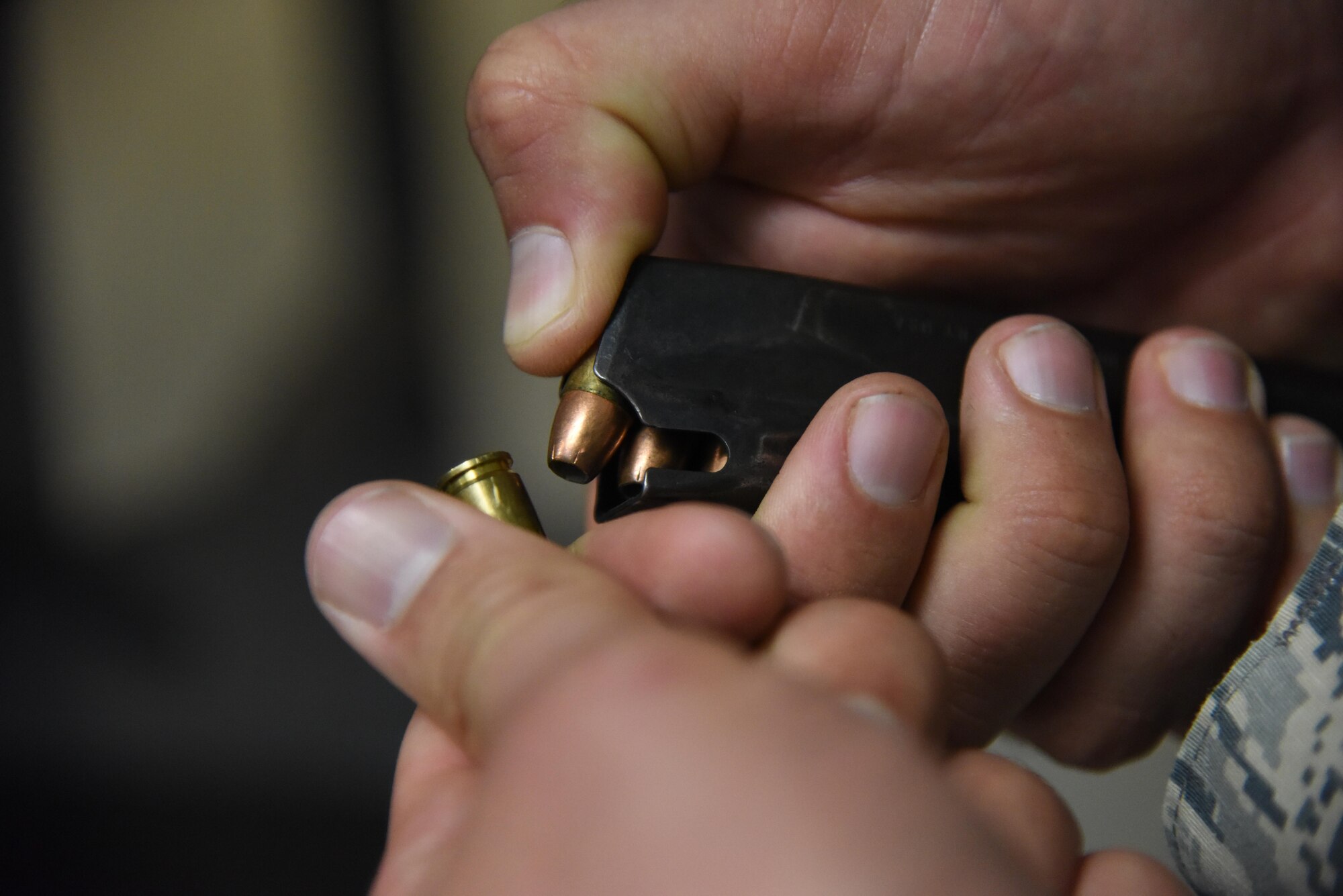 Staff Sgt. Joshua Green, 81st Security Forces Squadron combat arms instructor, loads ammo into a magazine during the 81st Security Forces Squadron “Top Shot” competition Dec. 1, 2016, on Keesler Air Force Base, Miss. The event was held at the indoor firing range to raise funds for the Combined Federal Campaign. (U.S. Air Force photo by Kemberly Groue)