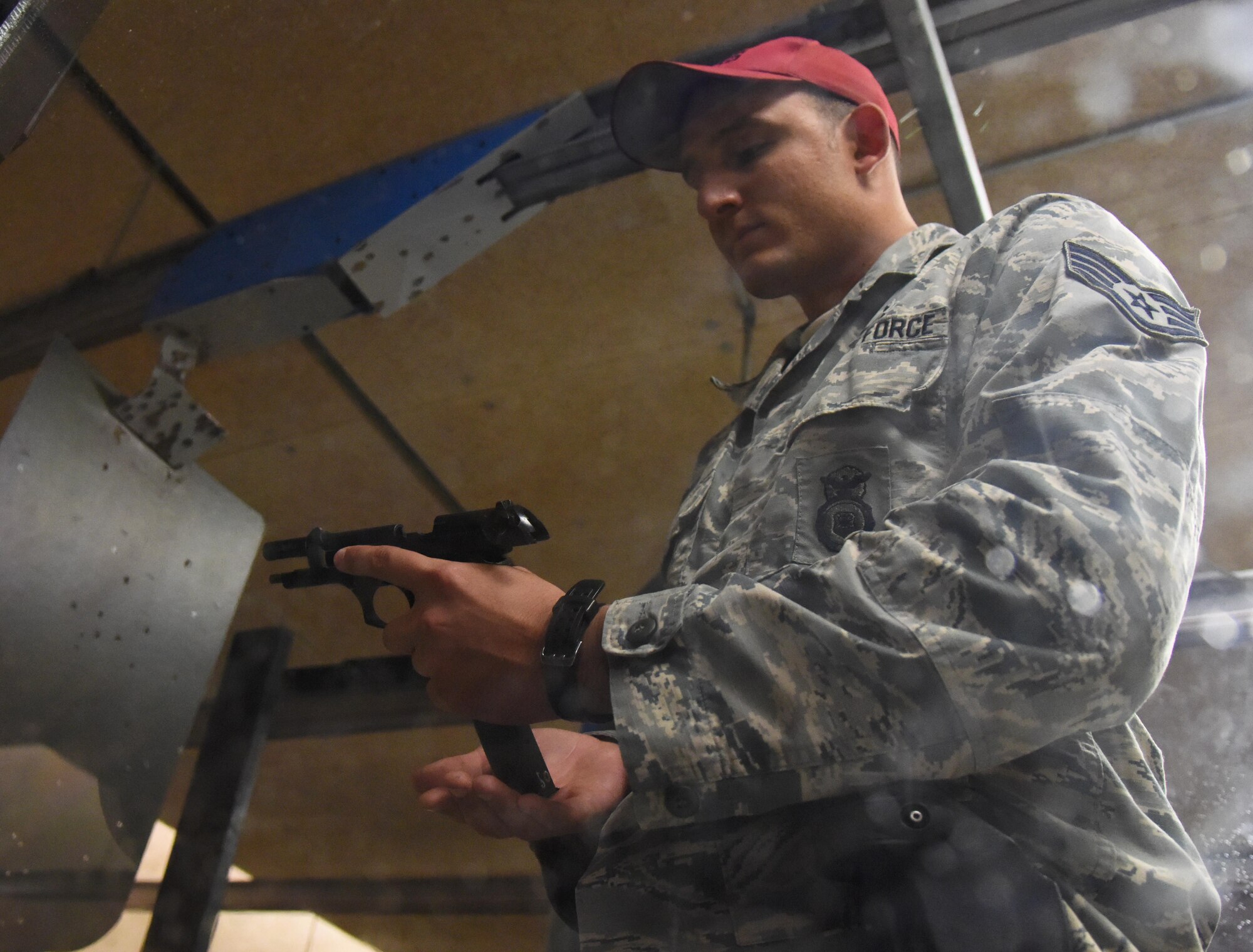 Staff Sgt. Joshua Green, 81st Security Forces Squadron combat arms instructor, inserts a magazine into his weapon during the 81st Security Forces Squadron “Top Shot” competition Dec. 1, 2016, on Keesler Air Force Base, Miss. The event was held at the indoor firing range to raise funds for the Combined Federal Campaign. (U.S. Air Force photo by Kemberly Groue)
