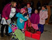 Children and spouses of deployed Ellsworth service members pull a lever to light the Freedom Chapel Christmas tree at Ellsworth Air Force Base S.D., Dec. 1, 2016. The 28th Bomb Wing chaplain corps annually hosts this event, which provides Airmen and their families a chance to celebrate the holiday season with their fellow military community members. (U.S. Air Force photo by Airman 1st Class James L. Miller)