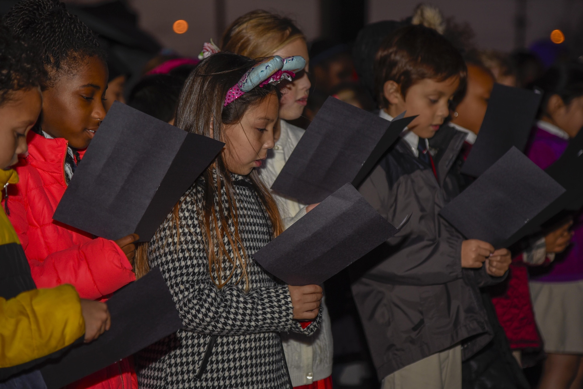 Imagine Andrews Public Charter School’s students sing holiday carols at the Christmas tree lighting on Joint Base Andrews, Md., Dec. 1, 2016. The children sang Deck the Halls and Jing Bells in front of base members. The tree lighting is an annual event that provides the base with a time to celebrate holiday cheer. (U.S. Air Force photo by Airman 1st Class Valentina Lopez)