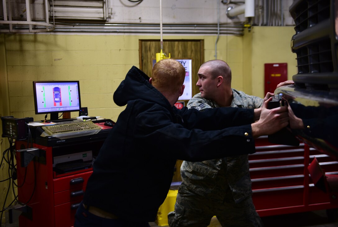 Airman 1st Class Kelsey Taylor and Senior Airman Kyle Nauman, vehicle maintenance technicians assigned to the 28th Logistics Readiness Squadron, pull a truck into position during a wheel alignment at Ellsworth Air Force Base, S.D., Nov. 29, 2016. Vehicle maintainers ensure Ellsworth’s fleet of more than 560 vehicles is mission ready at all times. (U.S. Air Force photo by Airman 1st Class James L. Miller) 