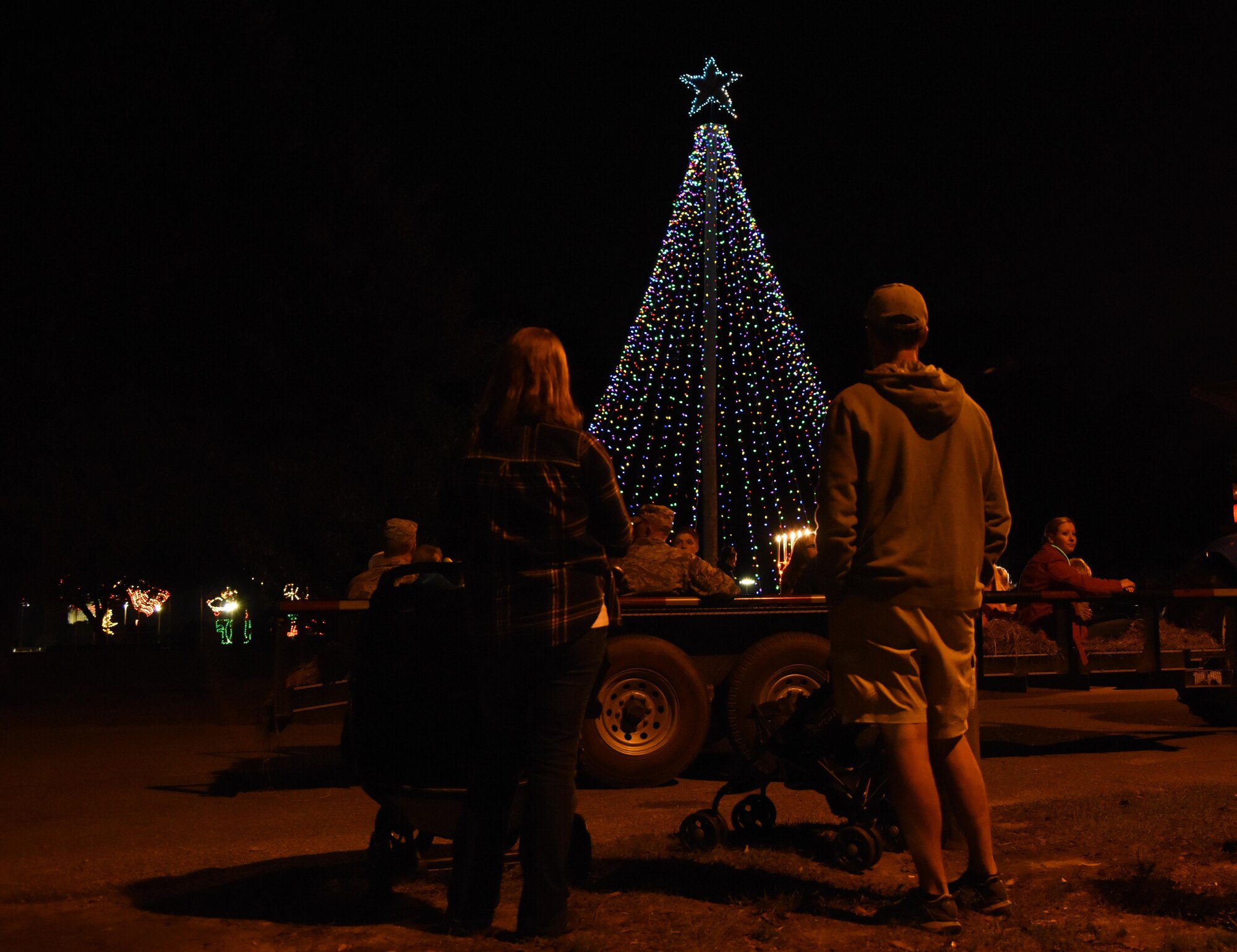 Keesler families look up at the tree light display following a tree lighting ceremony during Keesler’s annual Christmas in the Park celebration at Marina Park Dec. 1, 2016, on Keesler Air Force Base, Miss. The event, hosted by Outdoor Recreation, also included tour train rides, cookie and ornament decorating, and visits with Santa. (U.S. Air Force photo by Kemberly Groue)
