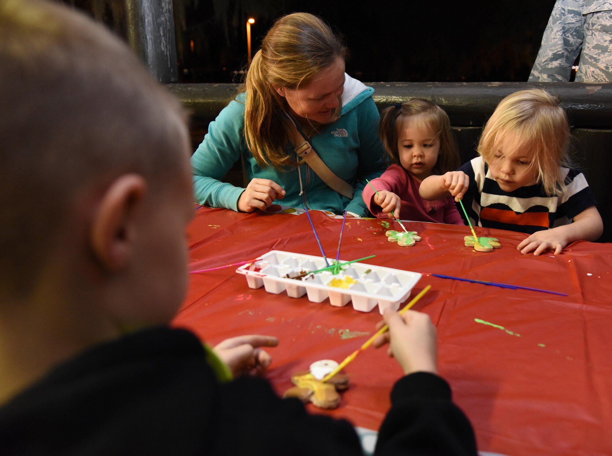 Becca, Charlotte, and Olivia, family of Maj. Andy Peterson, 81st Contracting Squadron commander, decorate ornaments during Keesler’s annual Christmas in the Park celebration at Marina Park Dec. 1, 2016, on Keesler Air Force Base, Miss. The event, hosted by Outdoor Recreation, also included a tree lighting ceremony, tour train rides, cookie decorating, and visits with Santa. (U.S. Air Force photo by Kemberly Groue)