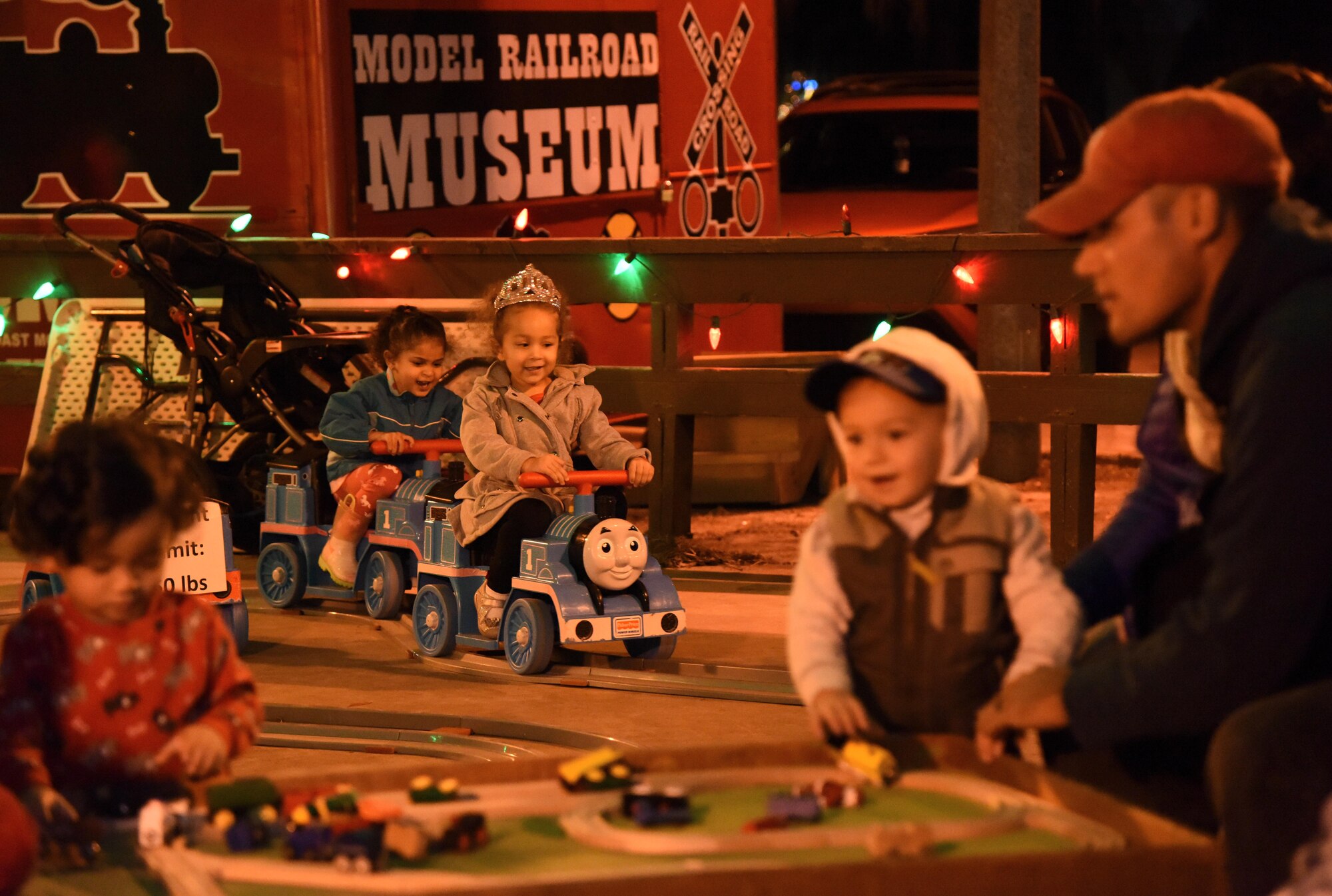 Alina Muthuveeran, daughter of Maj. Marlon Muthuveeran, 81st Medical Support Squadron Medical Readiness Flight commander, and Mila Rativa, daughter of Maj. Jorge Rativa, 333rd Training Squadron cyber course director, rides motorized toy trains during Keesler’s annual Christmas in the Park celebration at Marina Park Dec. 1, 2016, on Keesler Air Force Base, Miss. The event, hosted by Outdoor Recreation, also included a tree lighting ceremony, cookie and ornament decorating, and visits with Santa. (U.S. Air Force photo by Kemberly Groue)