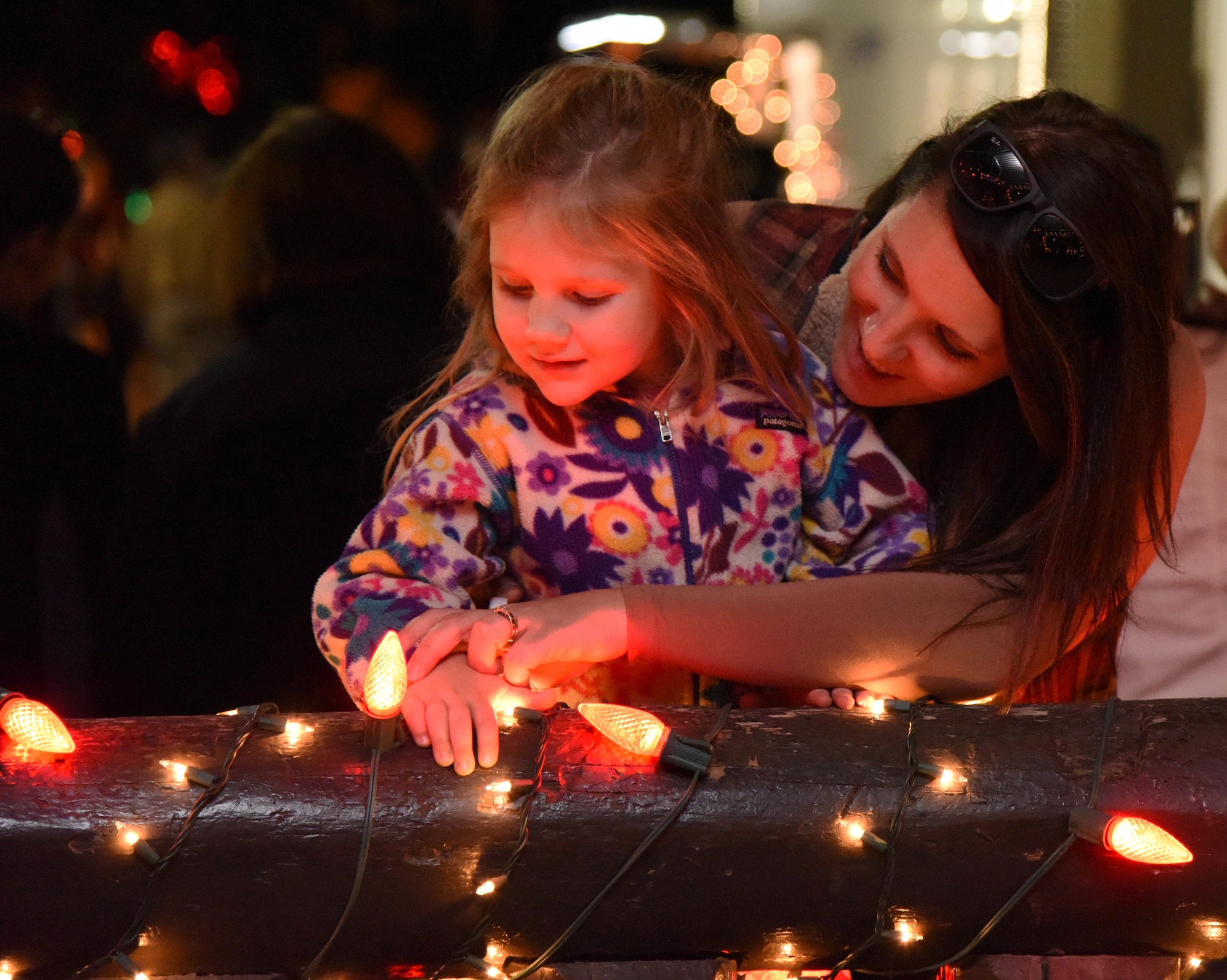 Diana White, 81st Force Support Squadron marketing specialist, and her daughter, Tensley, look at the lights during Keesler’s annual Christmas in the Park celebration at Marina Park Dec. 1, 2016, on Keesler Air Force Base, Miss. The event, hosted by Outdoor Recreation, included a tree lighting ceremony, tour train rides, cookie and ornament decorating, and visits with Santa. (U.S. Air Force photo by Kemberly Groue)