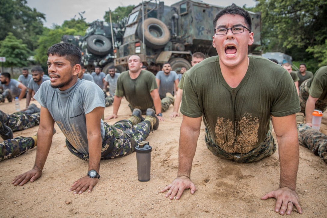 U.S. and Sri Lankan marines stretch after conducting physical training during a theater security cooperation engagement exercise in Trincomalee, Sri Lanka, Nov. 24, 2016. The exercise was the first engagement the 4-month-old Sri Lankan marine corps conducted with another marine corps organization. Marine Corps photo by Lance Cpl. Zachery Laning