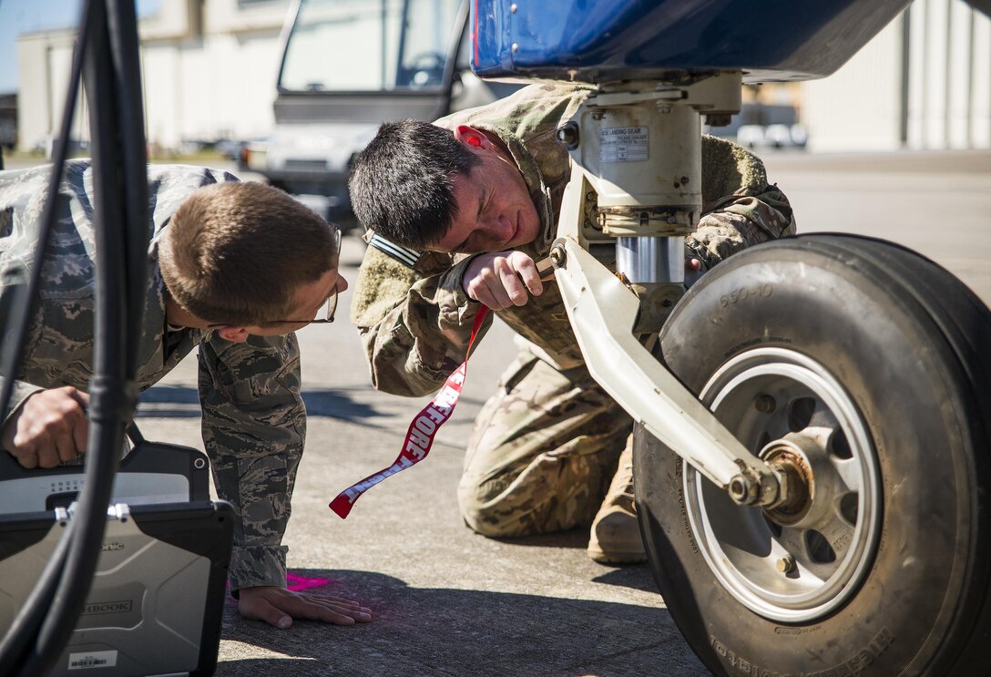 Staff Sgt. Sean Smith-Ogara, 919th Special Operations Maintenance Group, performs an inspection on the nose landing gear of a C-145A Skytruck during some routine maintenance on the flightline at Duke Field Fla., Feb. 25.  Smith-Ogara is part of the avionics shop of the 919th Special Operations Maintenance Group.  (U.S. Air Force photo/Tech. Sgt. Sam King)