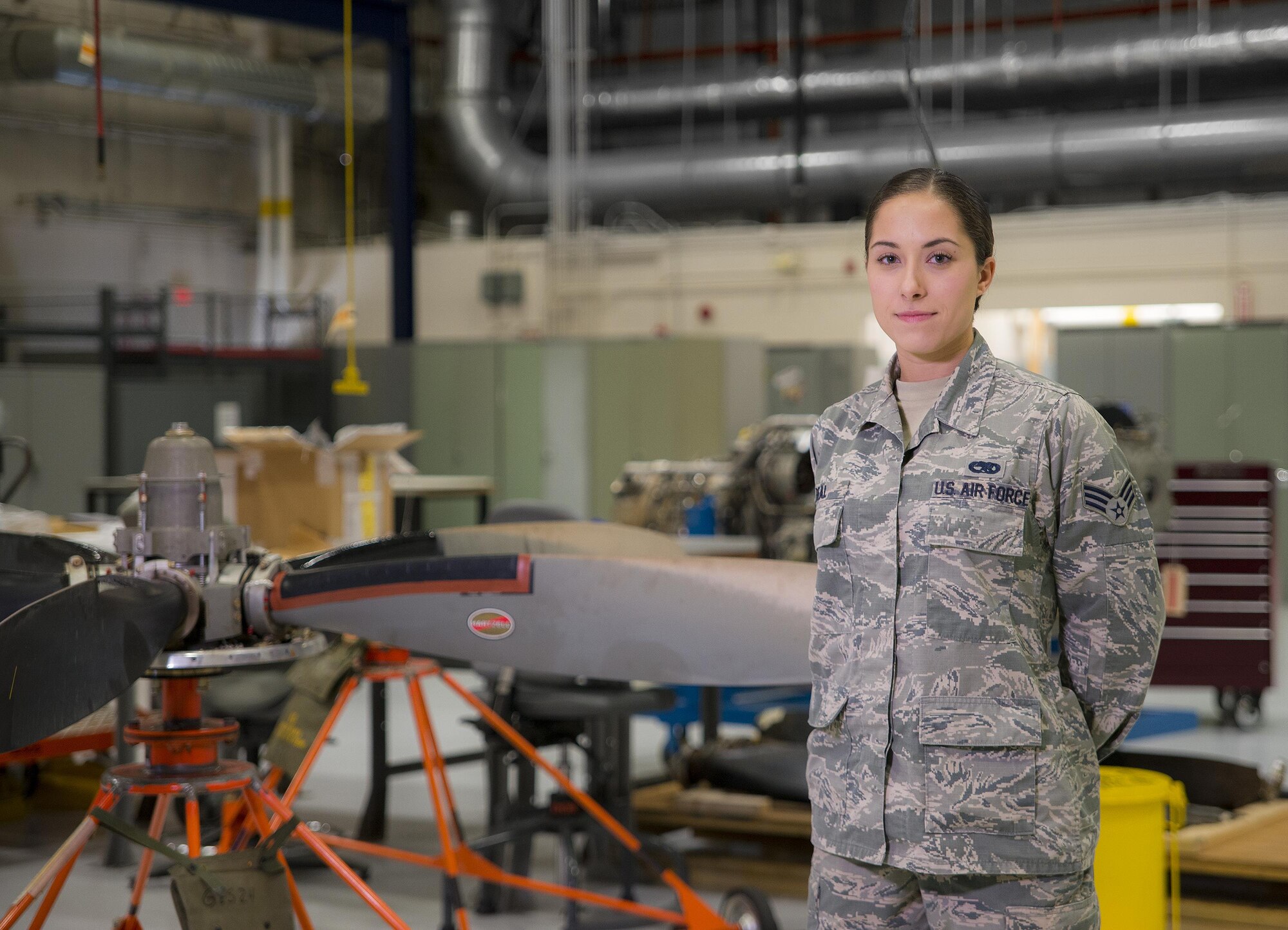 Senior Airman Natalie Beal, 919th Special Operations Maintenance Group, stands by a C-146 Wolfhound propellor at Duke Field Fla., Feb. 25.  The Airmen are part of the engine shop of the 919th Special Operations Maintenance Group.  (U.S. Air Force photo/Tech. Sgt. Sam King)