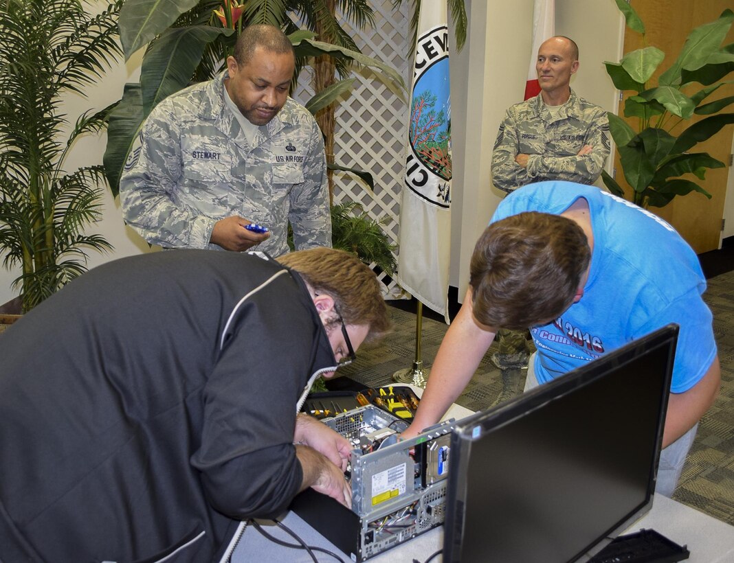 Members of the 919th Special Operations Communications Squadron watch and keep time while kids put together a desktop computer at this year’s Tech Bowl in Niceville Fla., Nov. 5.  The reservists acted as timekeepers and judges for the youth competition.  (Courtesy photo)