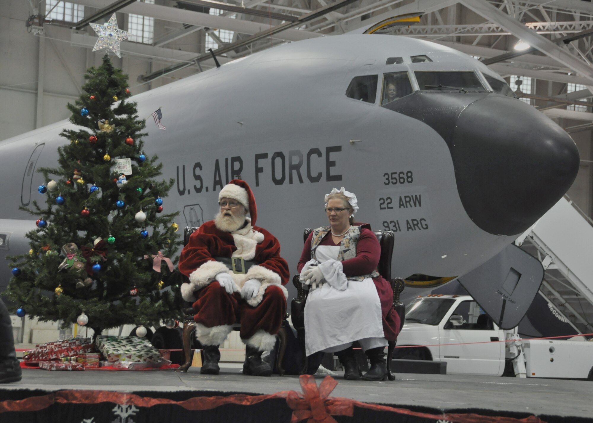“Santa Claus” meets with children during the 22nd Air Refueling Wing Children’s Holiday Party Dec. 3, 2016, McConnell Air Force Base, Kans. Children were given the opportunity to meet with “Santa” in front of a KC-135 Stratotanker for pictures. (U.S. Air Force Photo by Senior Airman Preston Webb)