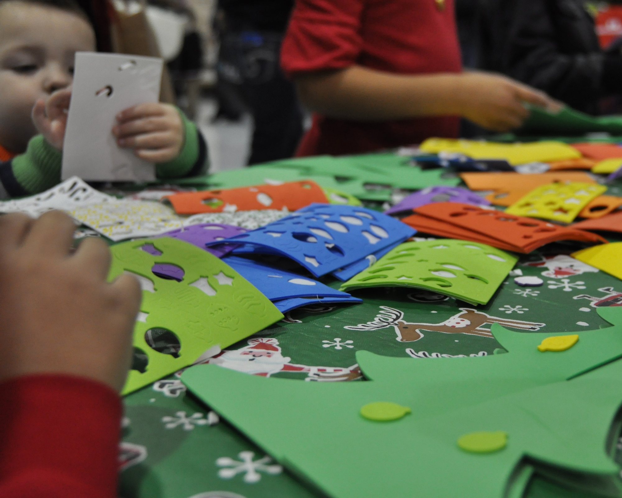 Team McConnell children craft miniature Christmas trees during the 22nd Air Refueling Wing Children’s Holiday Party Dec. 3, 2016, McConnell Air Force Base, Kans. The party featured several stations for children to create holiday decorations. (U.S. Air Force Photo by Senior Airman Preston Webb)